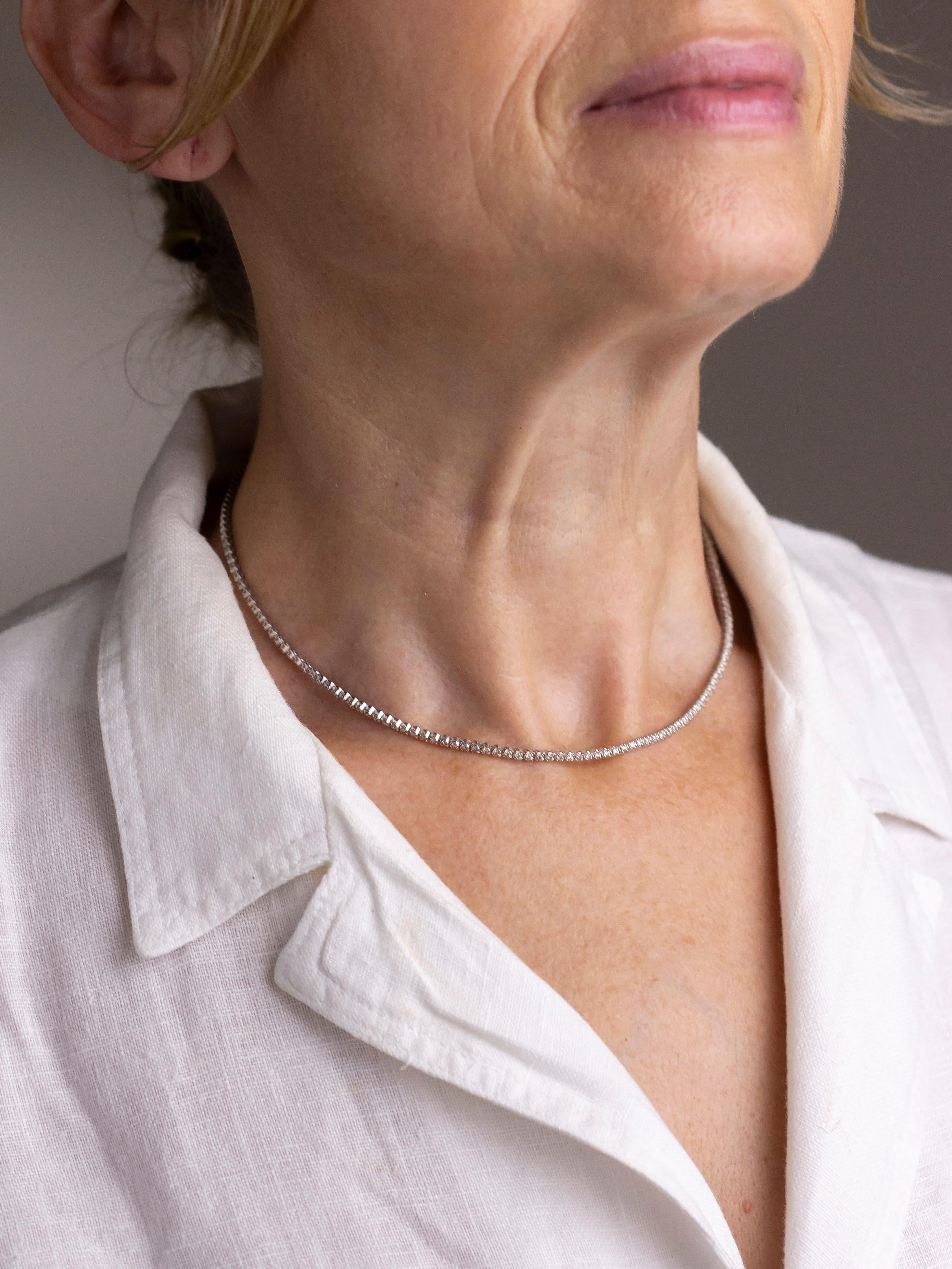 Crafted from 14 karat white gold, this necklet is what is typically called a 'Tennis' necklace. The fine gold necklet has been set with 166 round brilliant cut diamonds which are each K-M in colour and VS-SI in clarity totalling 2.50 carat. Each of