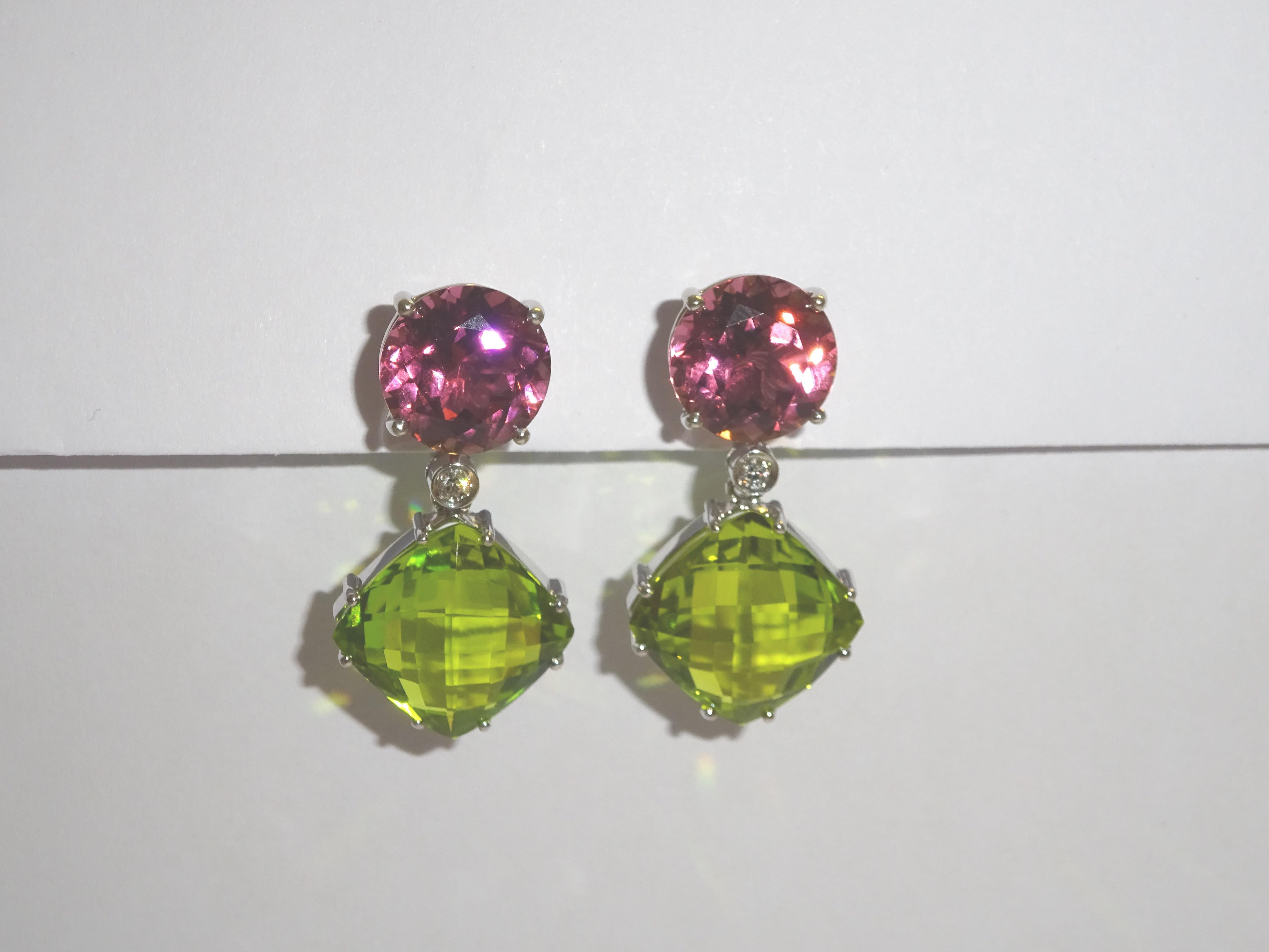 A magnificent pair of contemporary Diamond, Turmaline and Peridot drop Earrings. The earrings are mounted in 18 Karat white gold encrusted with vidid and truly stunning oval gemstones. These sensational earrings epitomize elegance and