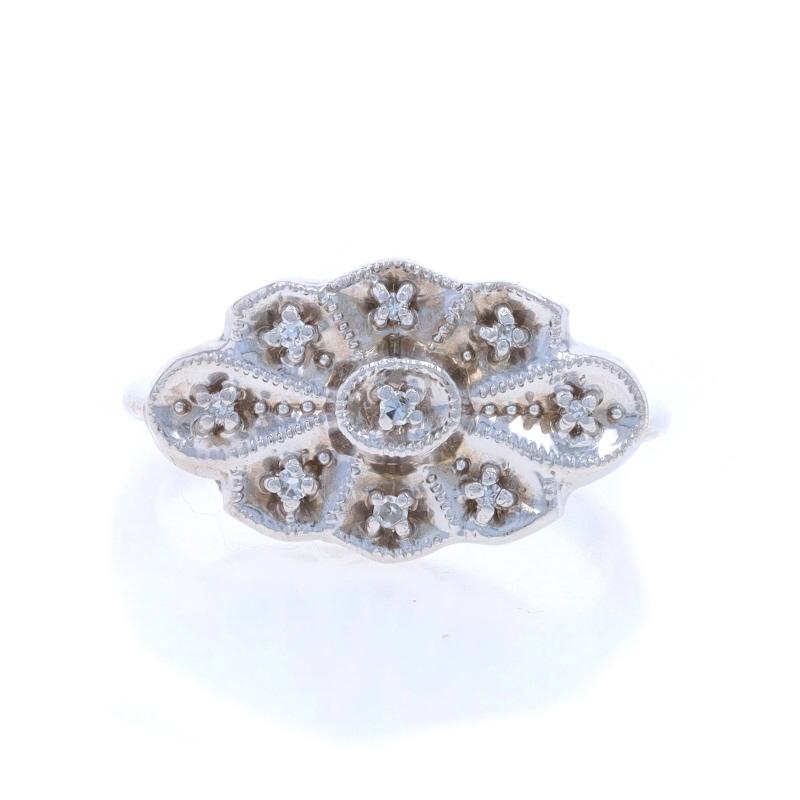 Size: 5 1/2
Sizing Fee: Up 2 sizes for $40 or Down 1 size for $40

Era: Vintage

Metal Content: 14k White Gold

Stone Information

Natural Diamonds
Carat(s): .05ctw
Cut: Single
Color: H - I
Clarity: VS1 - VS2

Style: Cluster
Theme: Floral
