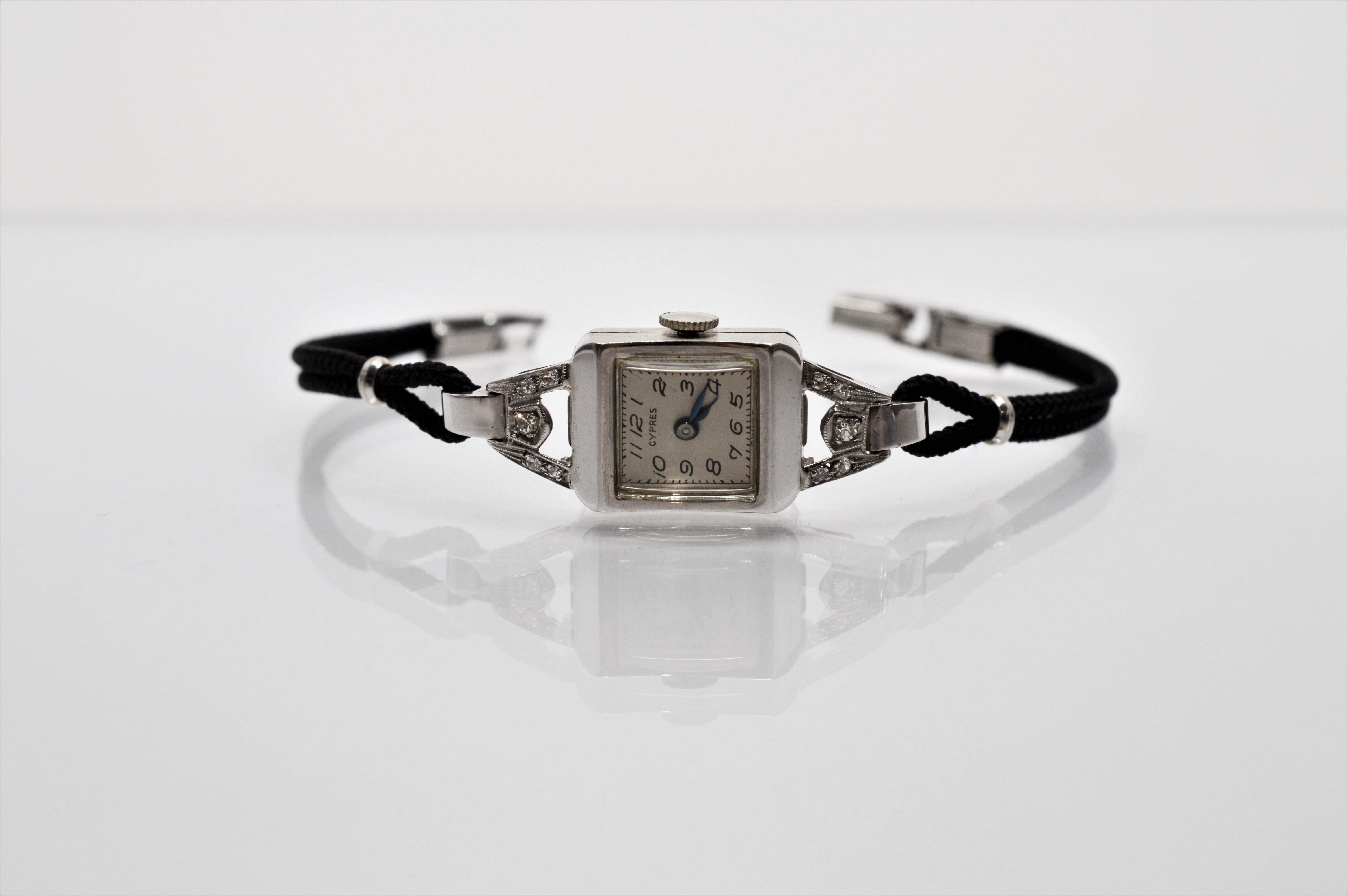 Classic vintage bracelet wrist watch with diamonds in fourteen karat white gold. Has working Swiss Dreffa 17 jeweled movement. The petite square watch head measures 1/2 x 5/8 inch and ten diamonds adorn the lugs at the top and bottom of the head.