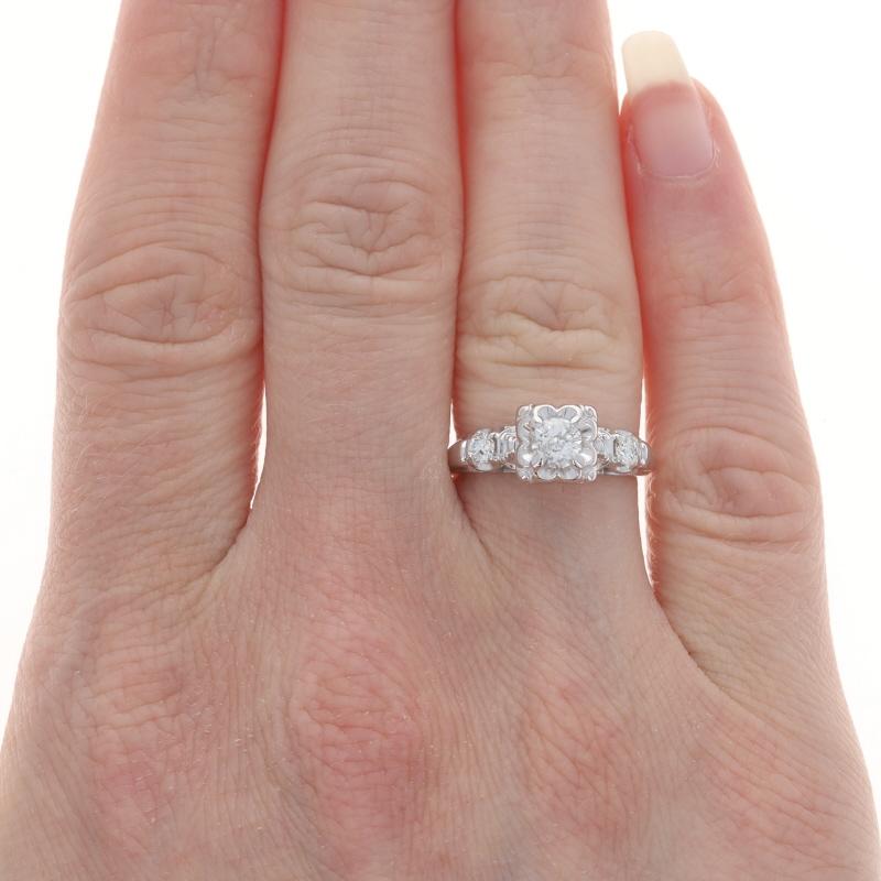 Size: 5 1/4
Sizing Fee: Up 1 1/2 sizes for $40 or Down 1 size for $40

Year: 1960s - 1970s
Era: Vintage

Metal Content: 14k White Gold

Stone Information

Natural Diamond
Carat(s): .35ct
Cut: Round Brilliant
Color: F
Clarity: SI2

Natural
