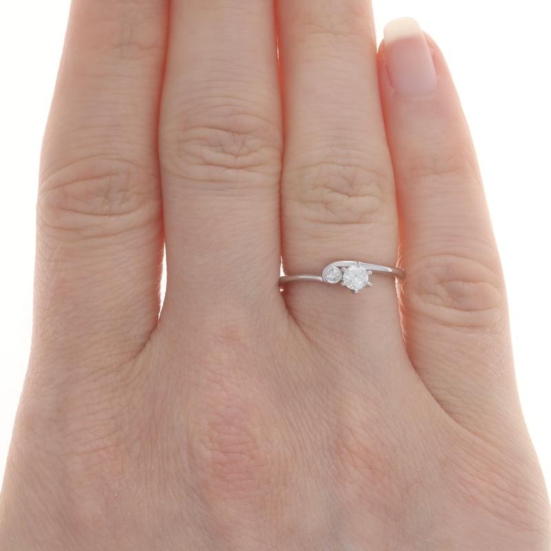 Size: 5
Sizing Fee: Up 2 sizes for $60 or Down 2 sizes for $40

Era: Vintage

Metal Content: 14k White Gold

Stone Information

Natural Diamond
Carat(s): .16ct
Cut: Round Brilliant
Color: H
Clarity: I1

Natural Diamonds
Carat(s): .05ctw
Cut:
