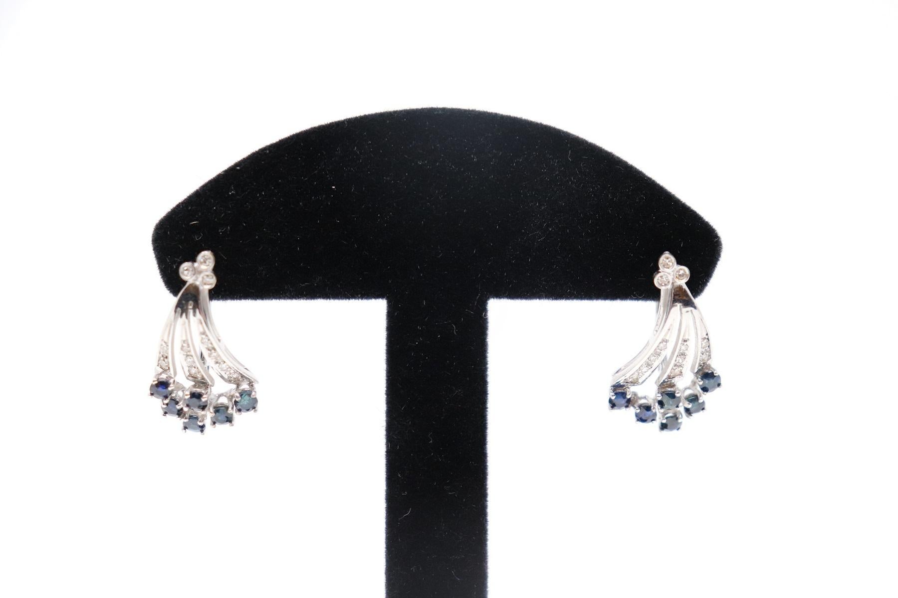 18 Karat white gold fashion drop earring with Central Blue Sapphire about 0.062 Carats and brilliant cut diamonds total about 0.25 Carats. 
Total weight: about 6.10 g.
New contemporary jewelry. Produced in the famous Italian city of gold Valenza.