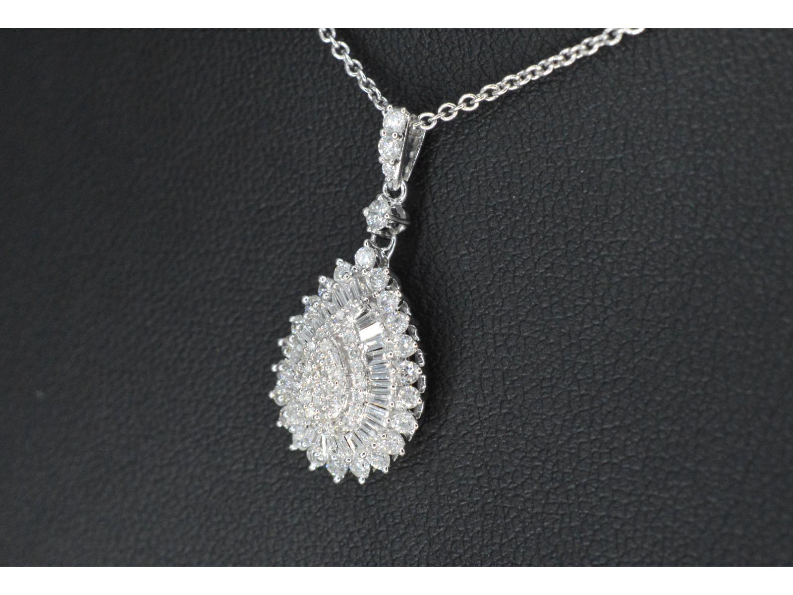 Introducing a stunning pendant, adorned with a beautiful combination of brilliant-cut and baguette-cut diamonds. The total diamond weight is 0.75 carat, with a color grading of F-G and a clarity ranging from SI to P. The quality of these diamonds is