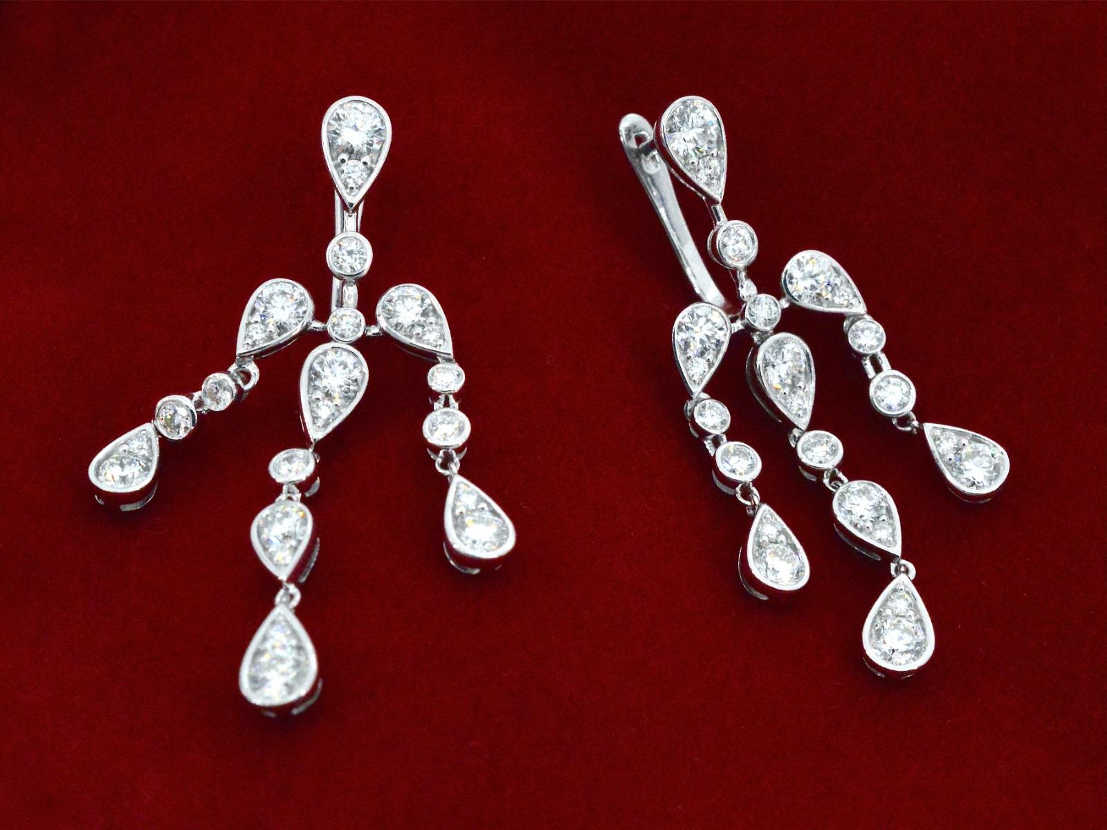 These 18K white gold earrings are a unique and special design featuring diamonds. The 18K white gold is a premium quality metal that is highly lustrous and durable. The diamonds used in these earrings are carefully selected for their exceptional