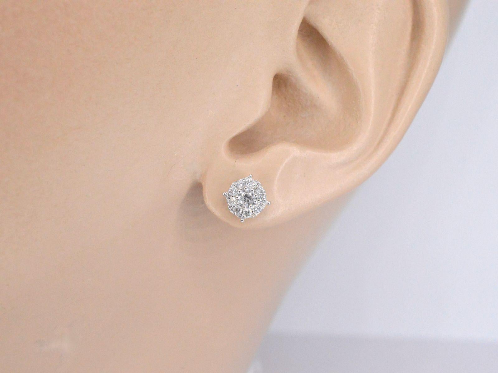These exquisite white gold earrings are composed of brilliant cut diamonds set in a classic round setting, creating a stunning and timeless design. The diamonds are expertly placed in a four-prong style, allowing for optimal light exposure and