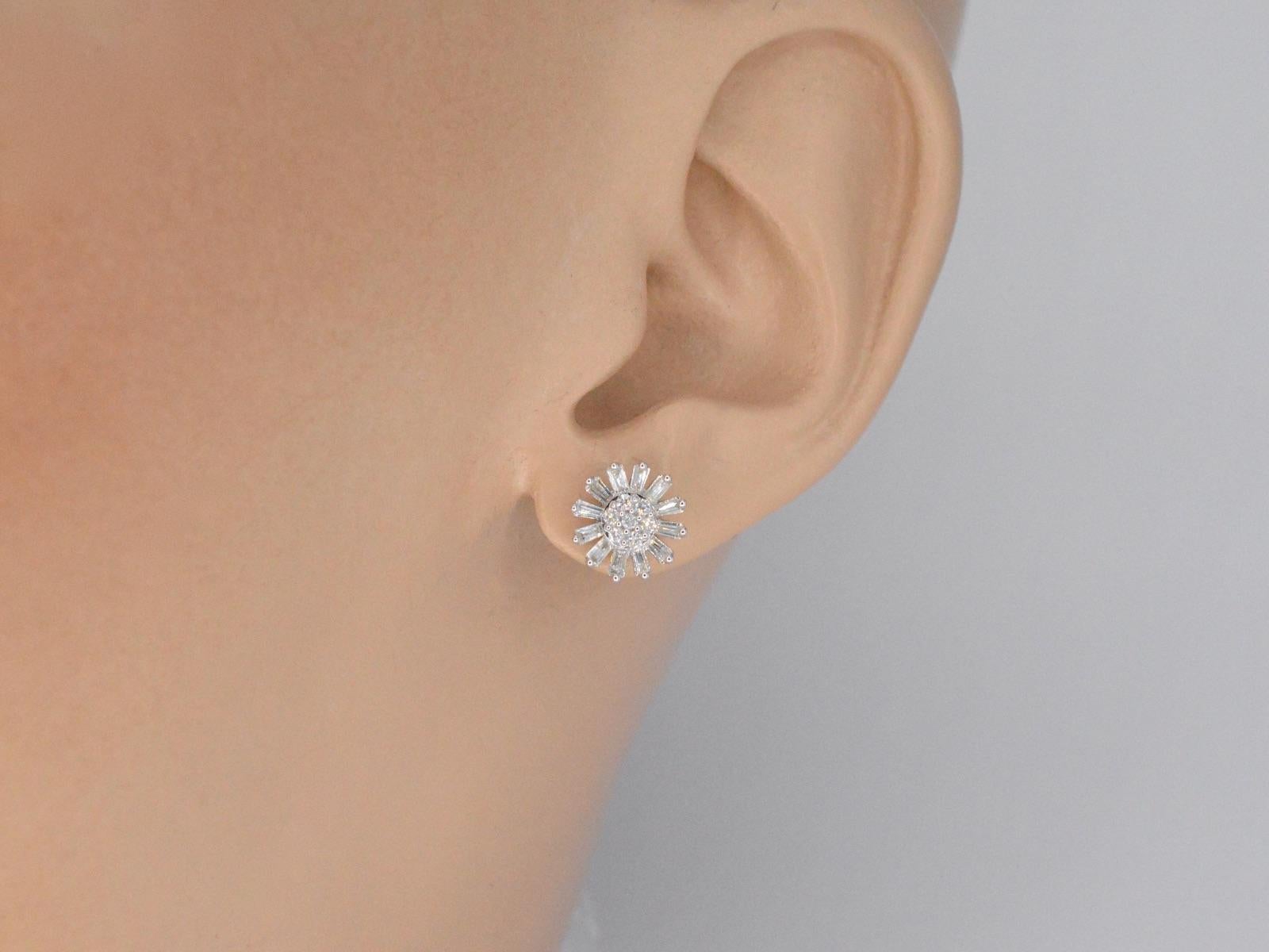 These white gold earrings feature a stunning flower design, adorned with 0.50 carats of natural genuine diamonds. The diamonds are expertly set in the white gold to create a seamless and elegant look that is perfect for any special occasion. The