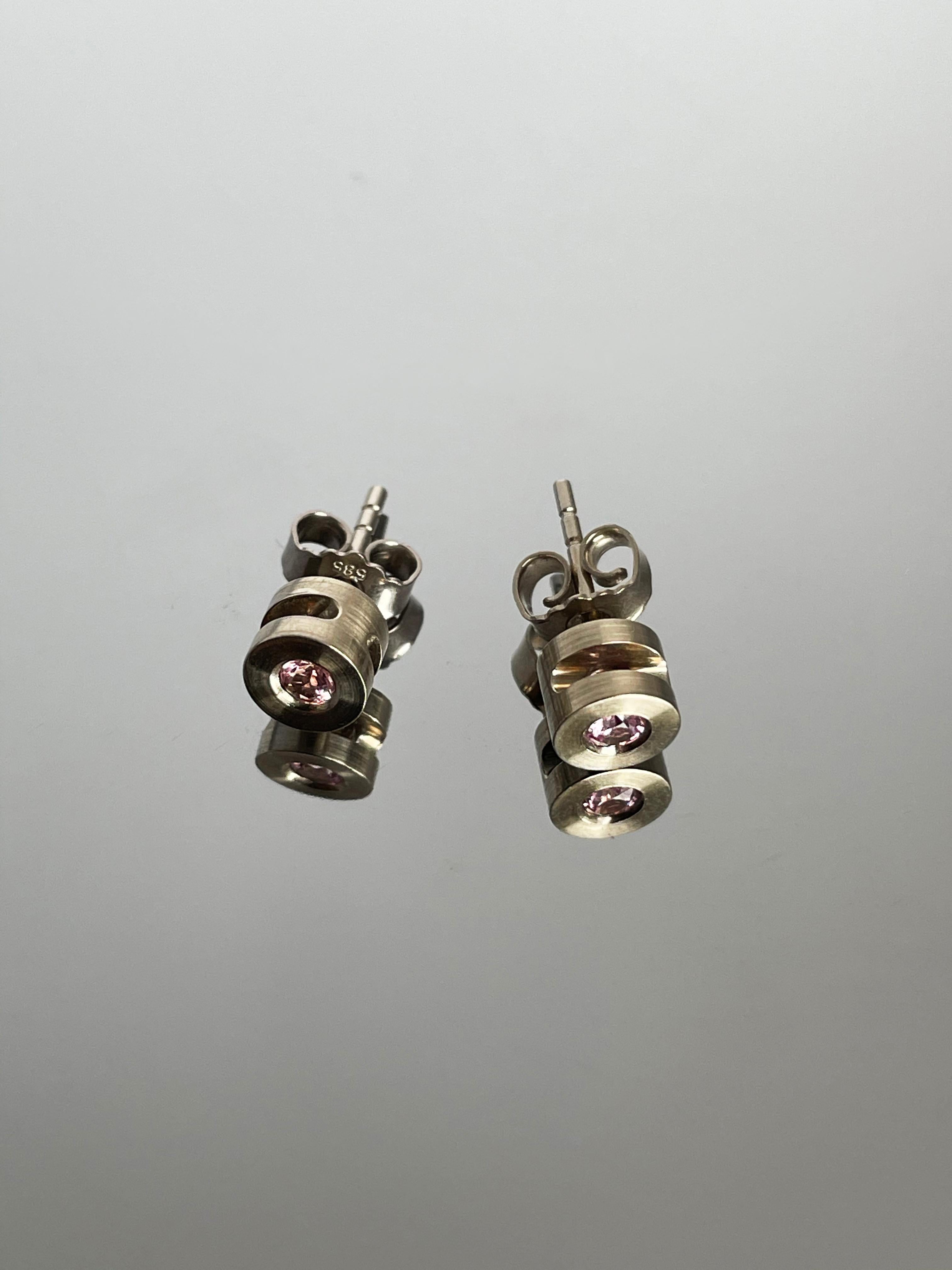This entirely handcrafted piece of jewelry harmoniously combines the stunning white gold, the charm of pink tourmaline, and the all-encompassing subtle, non-binding jewelry design, making these earrings the fabulous, eye-catching detail to your