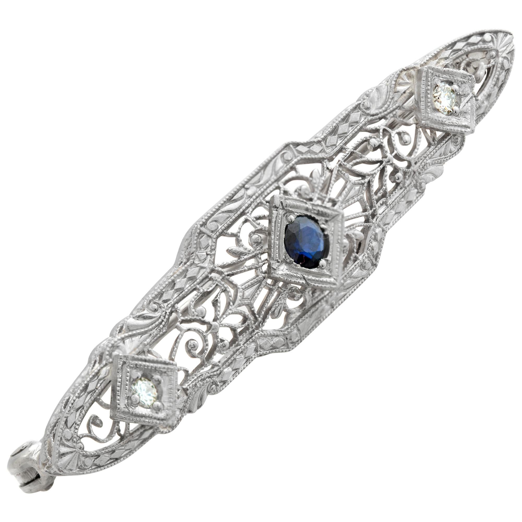 Edwardian pin in 14k white gold with center sapphire and 2 side accent diamonds. 1.75 inches in length. Width 9.5mm.
