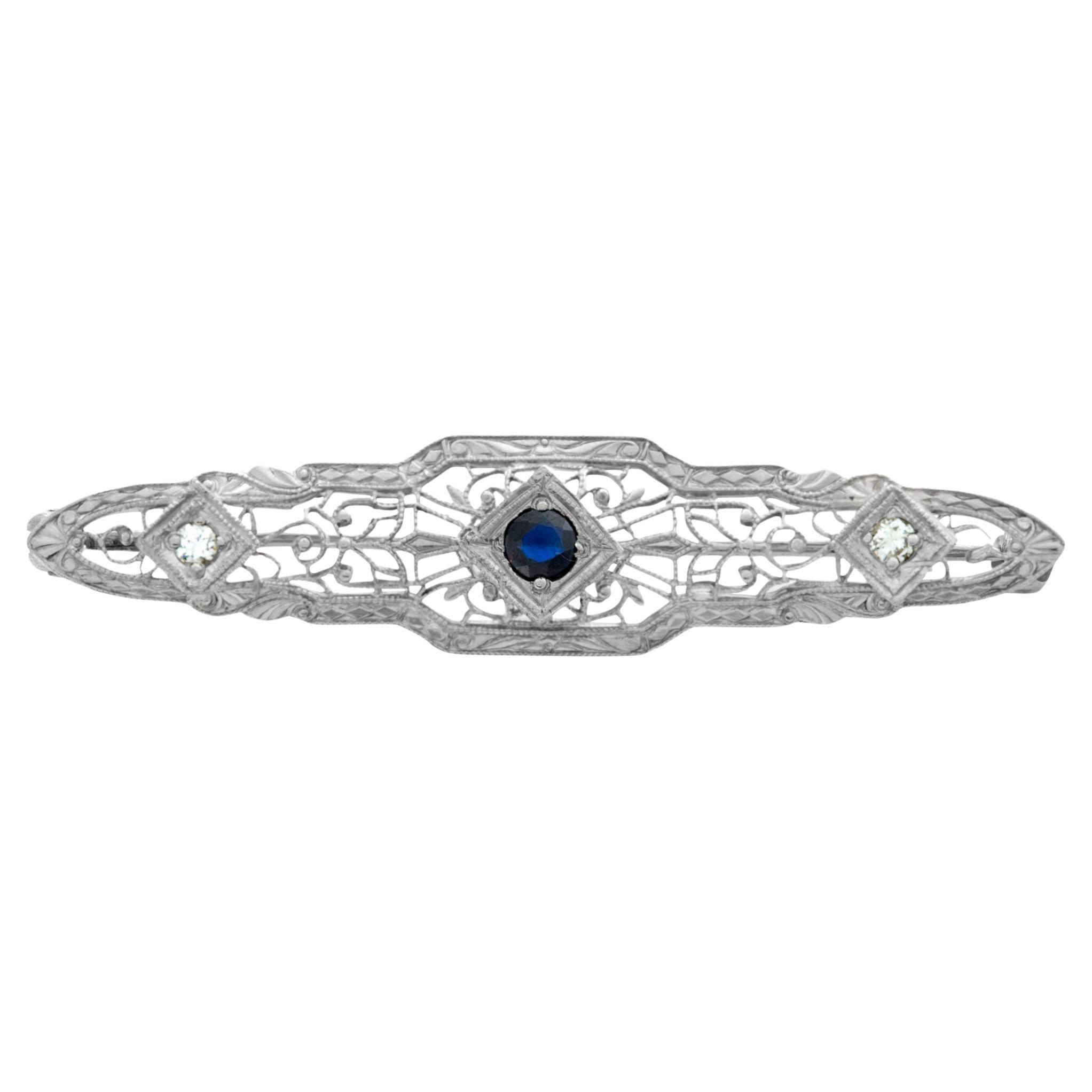 White gold Edwardian pin with center sapphire and 2 side accent diamonds