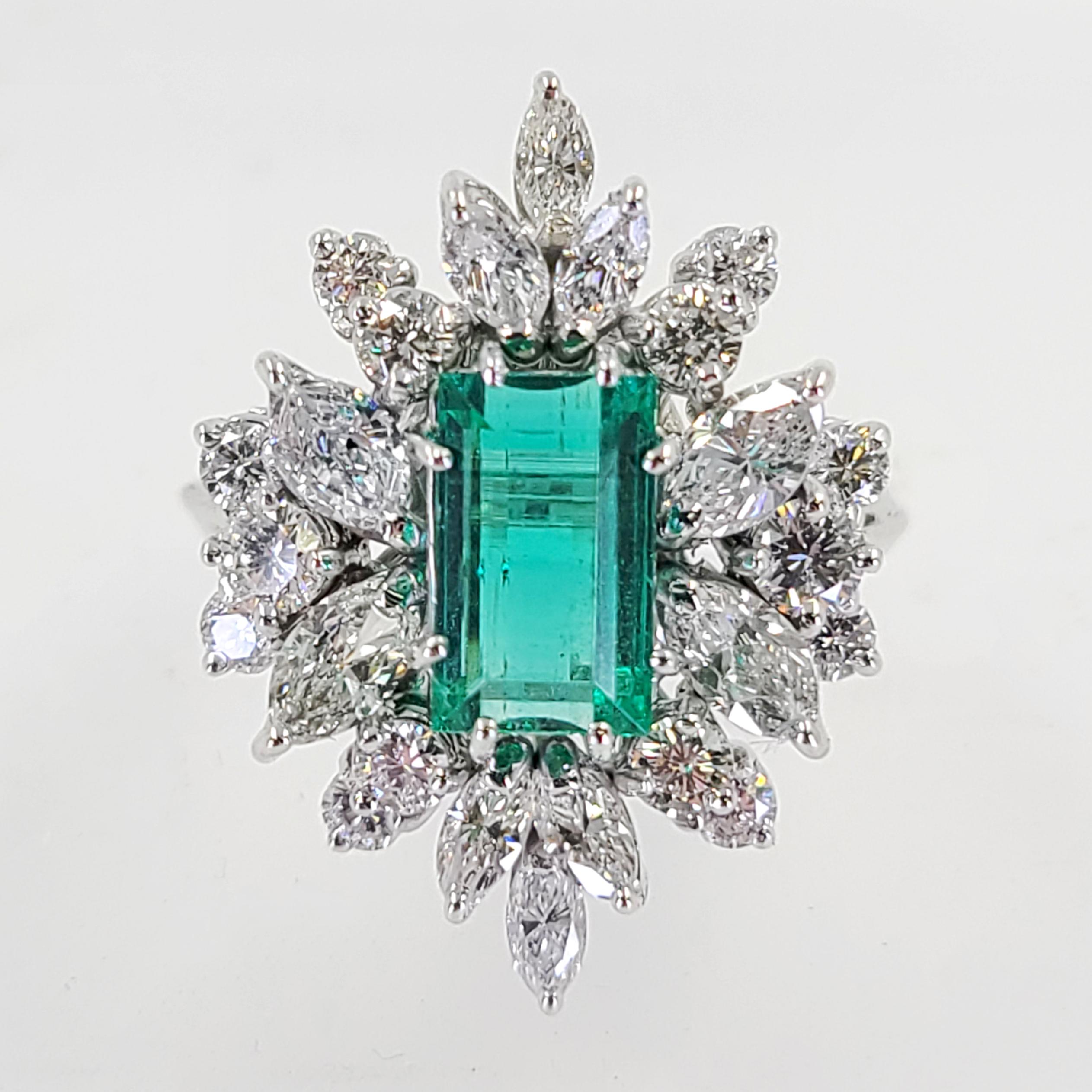 18 Karat White Gold Ring Featuring A 1.70 Carat Rectangular Cut Emerald Surrounded By 24 Marquise & Round Brilliant Cut Diamonds Of VS Clarity & G/H Color Totaling An Additional 2.00 Carats, Finger Size 6.25; Purchase Includes One Sizing Service