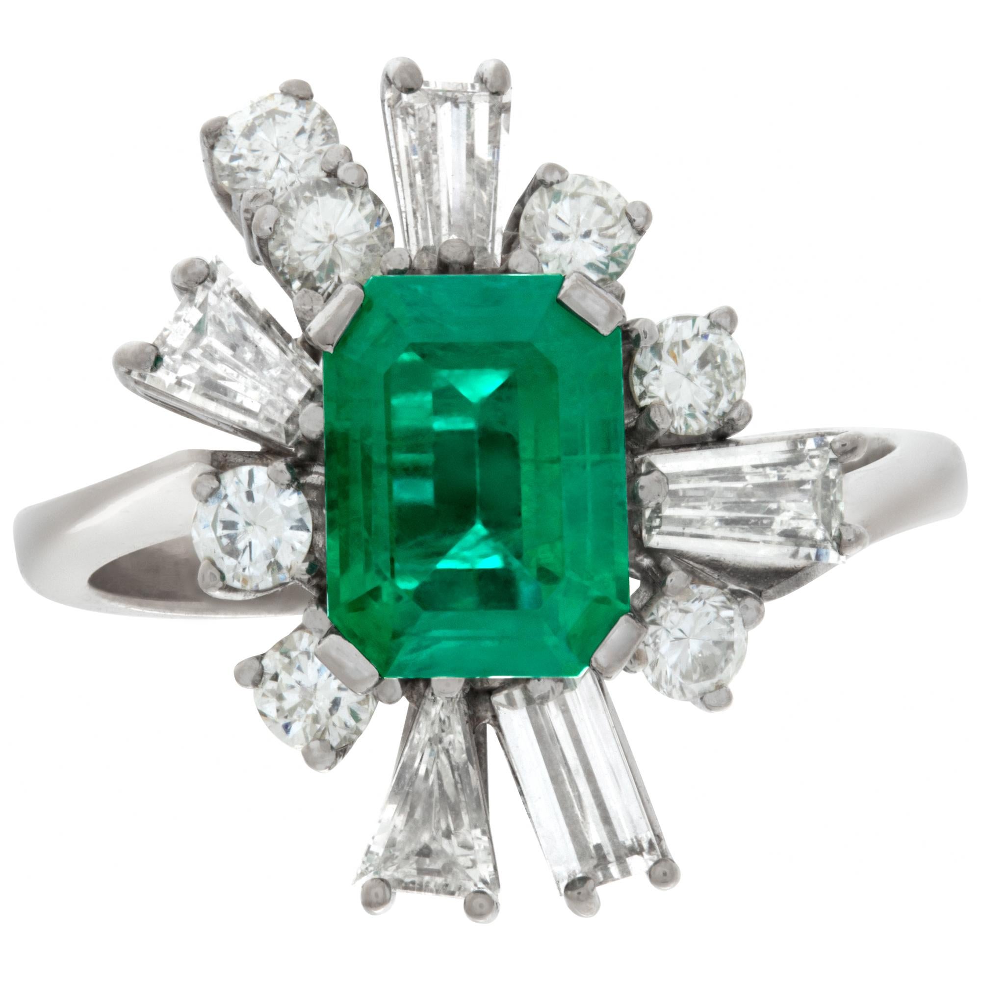 Lovely emerald and diamond cocktail ring in 14k white gold with approximately 1.25 caratt emerald and approximately 1 carat in round and baguette diamonds. Size 6.75.This Emerald ring is currently size 6.75 and some items can be sized up or down,