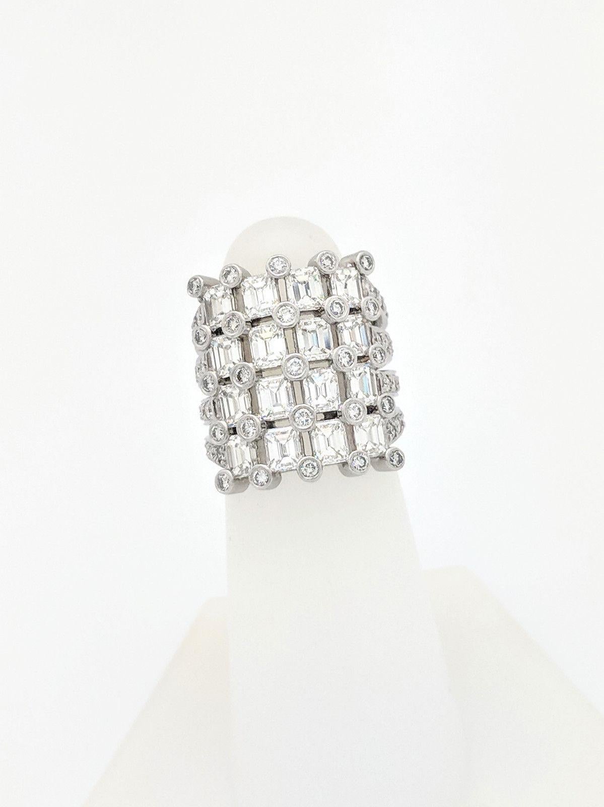You are viewing an exquisite Diamond Cocktail Ring. Any woman would love to add this one of a kind piece to their collection!

This ring is crafted from 18k white gold and weighs 14.5 grams. It features 3.95tcw of natural Emerald cut diamonds and