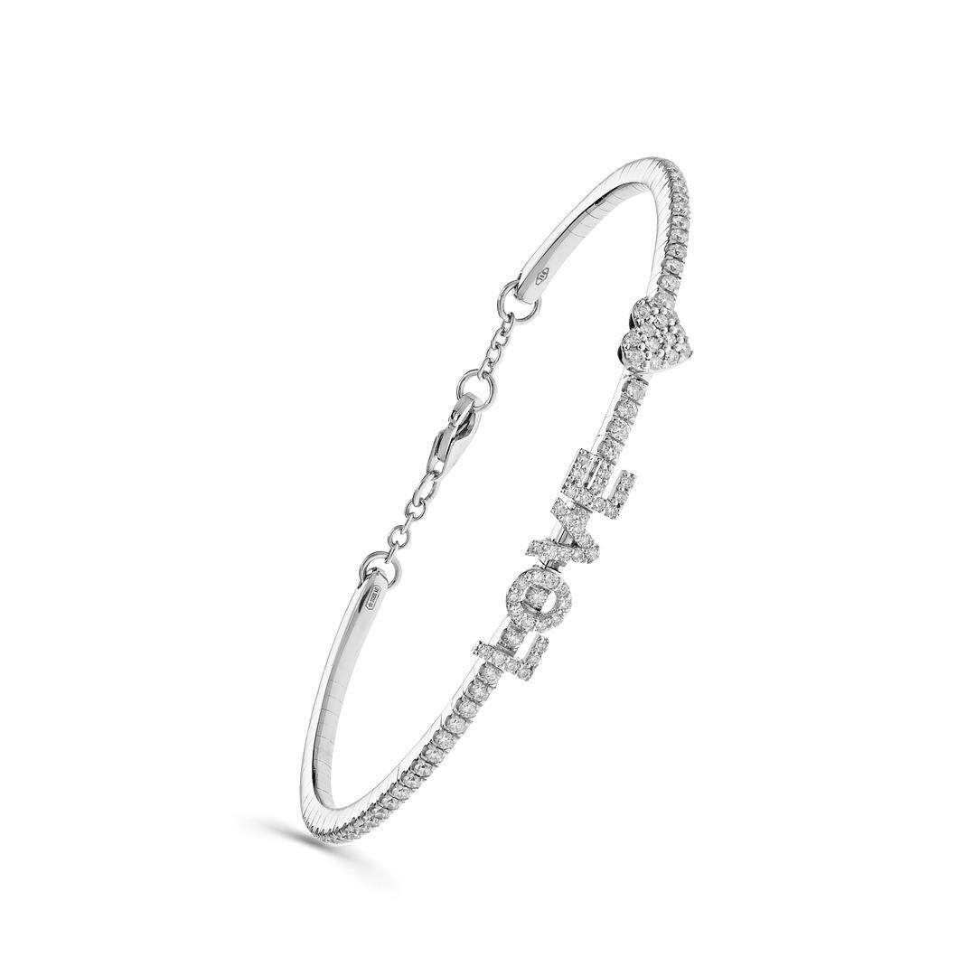 Embrace the essence of eternal love with our exquisite  White Gold 'Love' Bracelet. Pavé set with white round brilliant diamonds with a total weight of .85 carats. This bracelet features the diamond set word 'Love' with a heart and closes with a