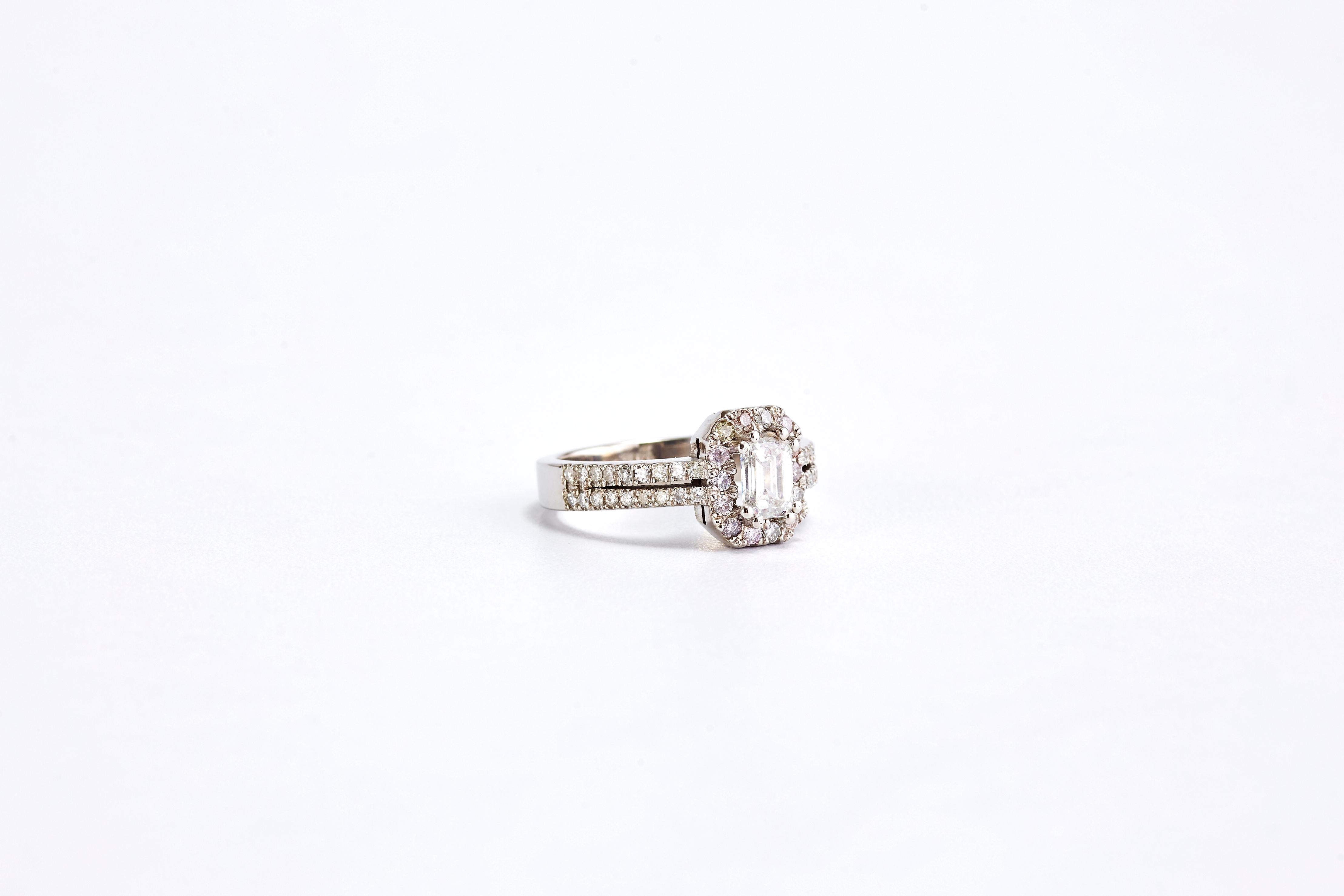 White Gold Emerald Cut Diamond Engagement Ring with a Halo

Unique design of a stunning white gold engagement ring with a special halo and 2 rows of diamonds on the band.
Center diamond 0.80 carat G VS1. Side diamonds are a total of 0.90 carat F VS1