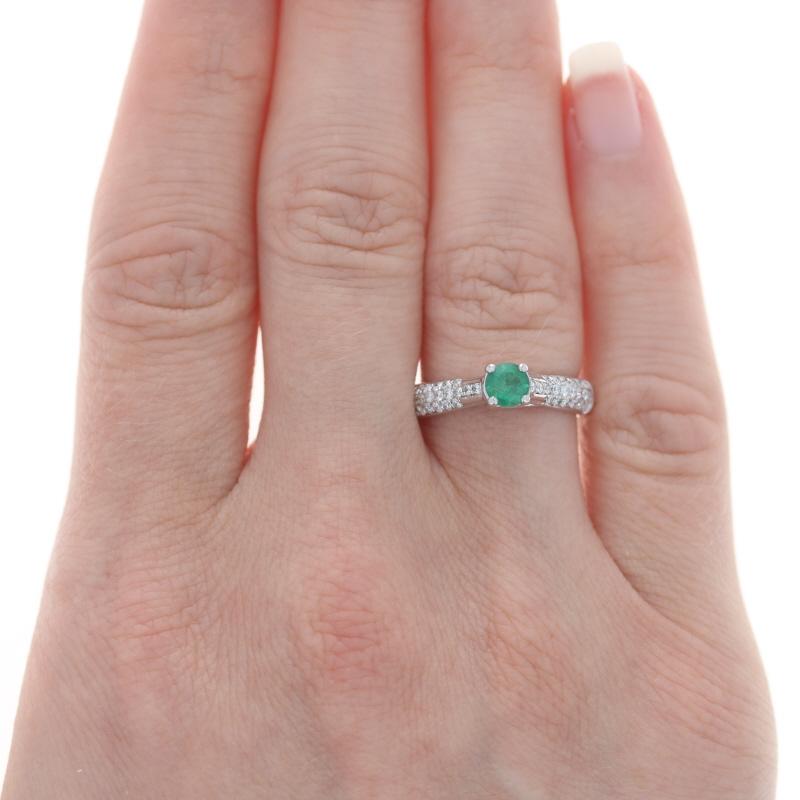 Size: 5 3/4
Sizing Fee: Up 2 sizes for $40

Metal Content: 18k White Gold

Stone Information

Natural Emerald
Treatment: Oiling
Carat(s): .27ct
Cut: Round
Color: Green

Natural Diamonds
Carat(s): .40ctw
Cut: Round Brilliant
Color: G - H
Clarity: SI2