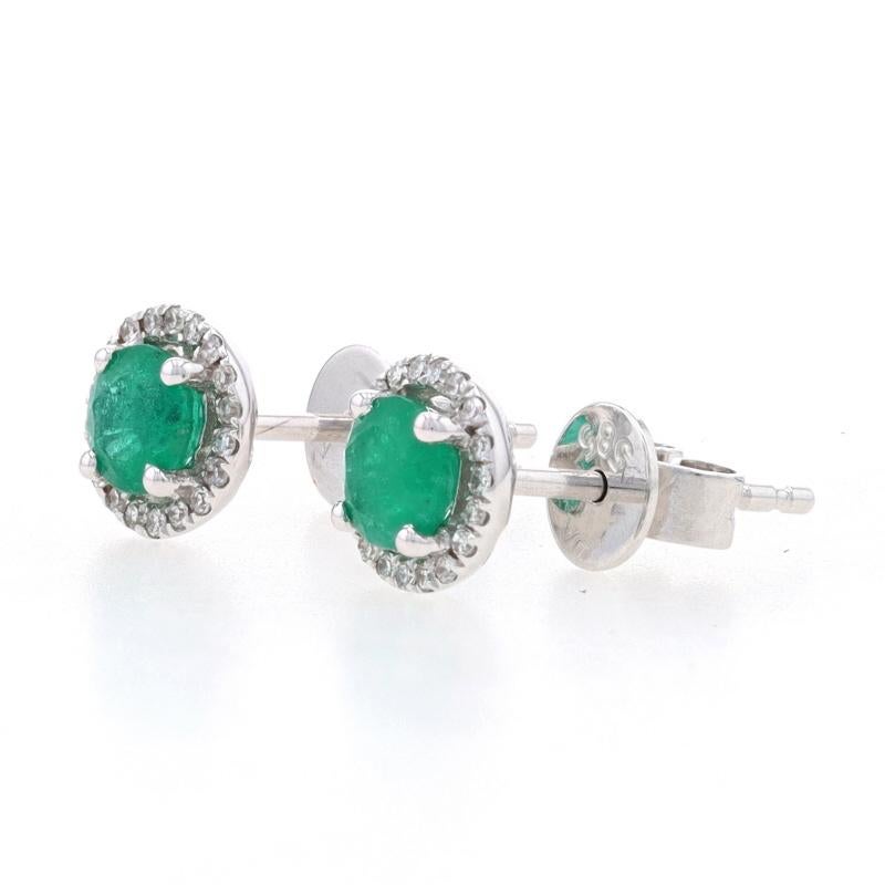 Metal Content: 14k White Gold

Stone Information
Natural Emeralds
Treatment: Oiling
Carats: .62ctw
Cut: Round
Color: Green

Natural Diamonds
Carats: .08ctw
Cut: Single
Color: F - G
Clarity: VS1 - VS2

Total Carats: .70ctw

Style: Halo Stud