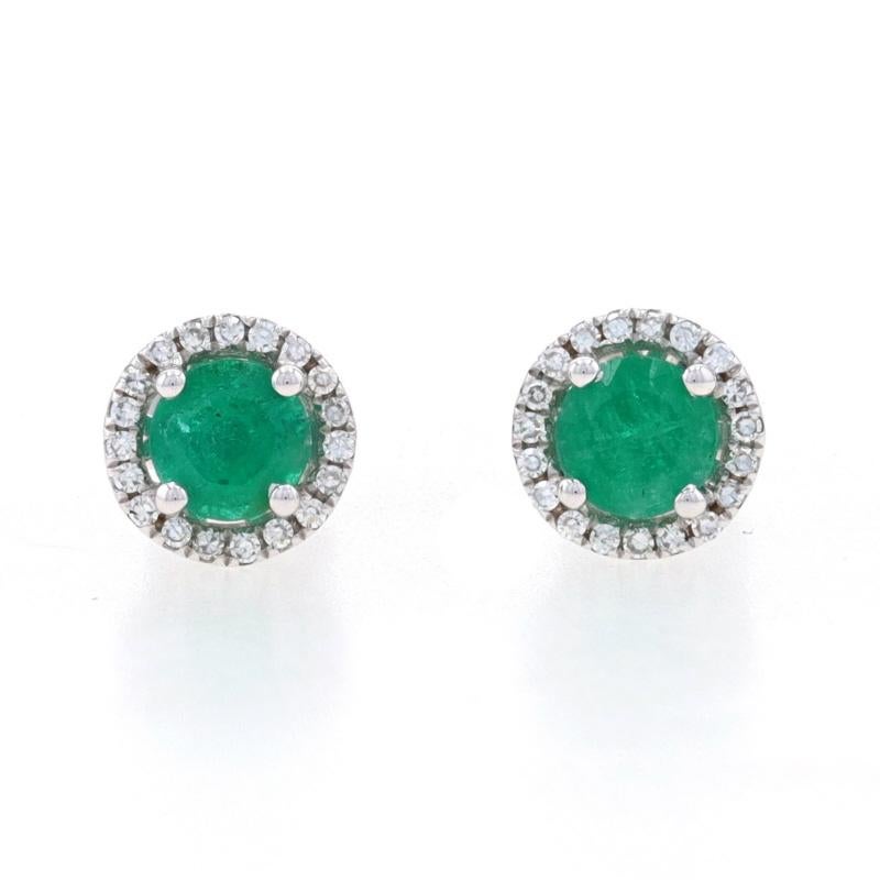Metal Content: 14k White Gold

Stone Information
Natural Emeralds
Treatment: Oiling
Carats: .62ctw
Cut: Round
Color: Green

Natural Diamonds
Carats: .08ctw
Cut: Single
Color: F - G
Clarity: VS1 - VS2

Total Carats: .70ctw

Style: Halo Stud