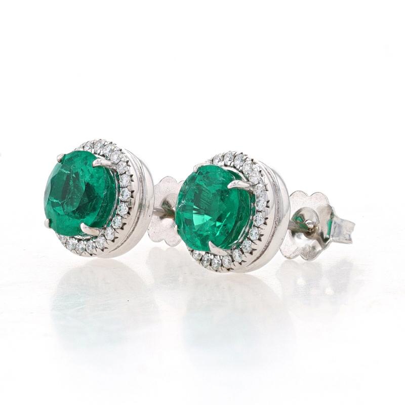 Metal Content: 18k White Gold

Stone Information
Natural Emerald
Treatment: No Clarity Enhancement
Carat(s): 1.26ct
Cut: Round
Color: Green
Origin: Colombia
Certified by: GIA
Report Number: 2225664130

Natural Emerald
Treatment: Clarity Enhanced
