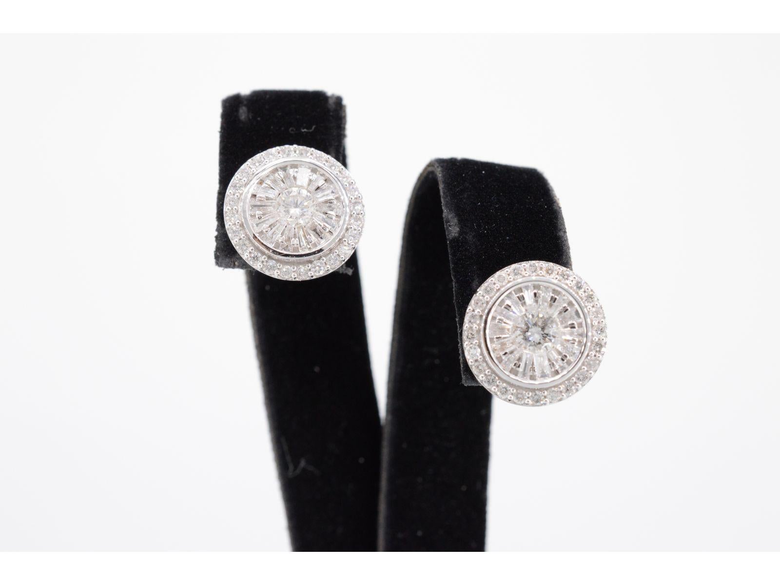 These stunning white gold entourage earrings are set with a combination of brilliant and baguette cut diamonds, totaling 1.20 carats. The diamonds are arranged in a striking entourage setting, creating a captivating display of light and sparkle. The