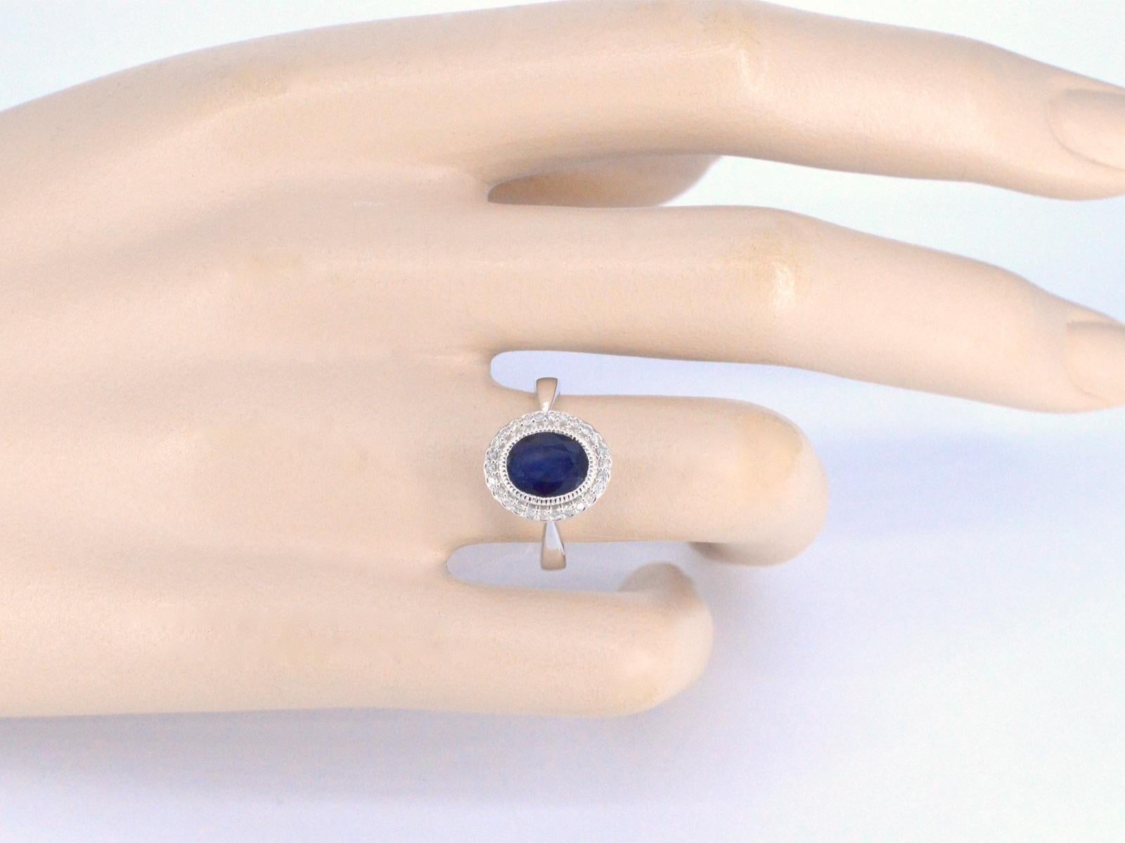 Contemporary White gold entourage ring with diamonds and sapphire For Sale