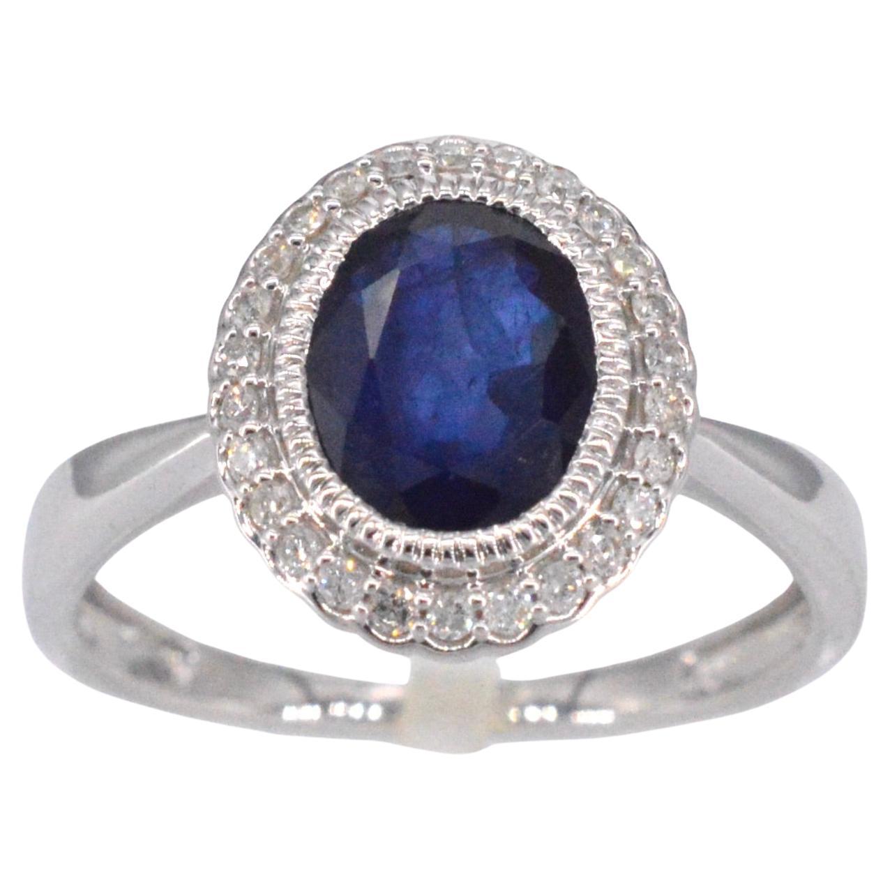 White gold entourage ring with diamonds and sapphire