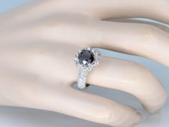 White gold entourage ring with large diamonds and a black diamond