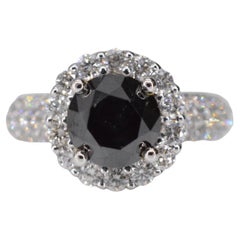 White gold entourage ring with large diamonds and a black diamond