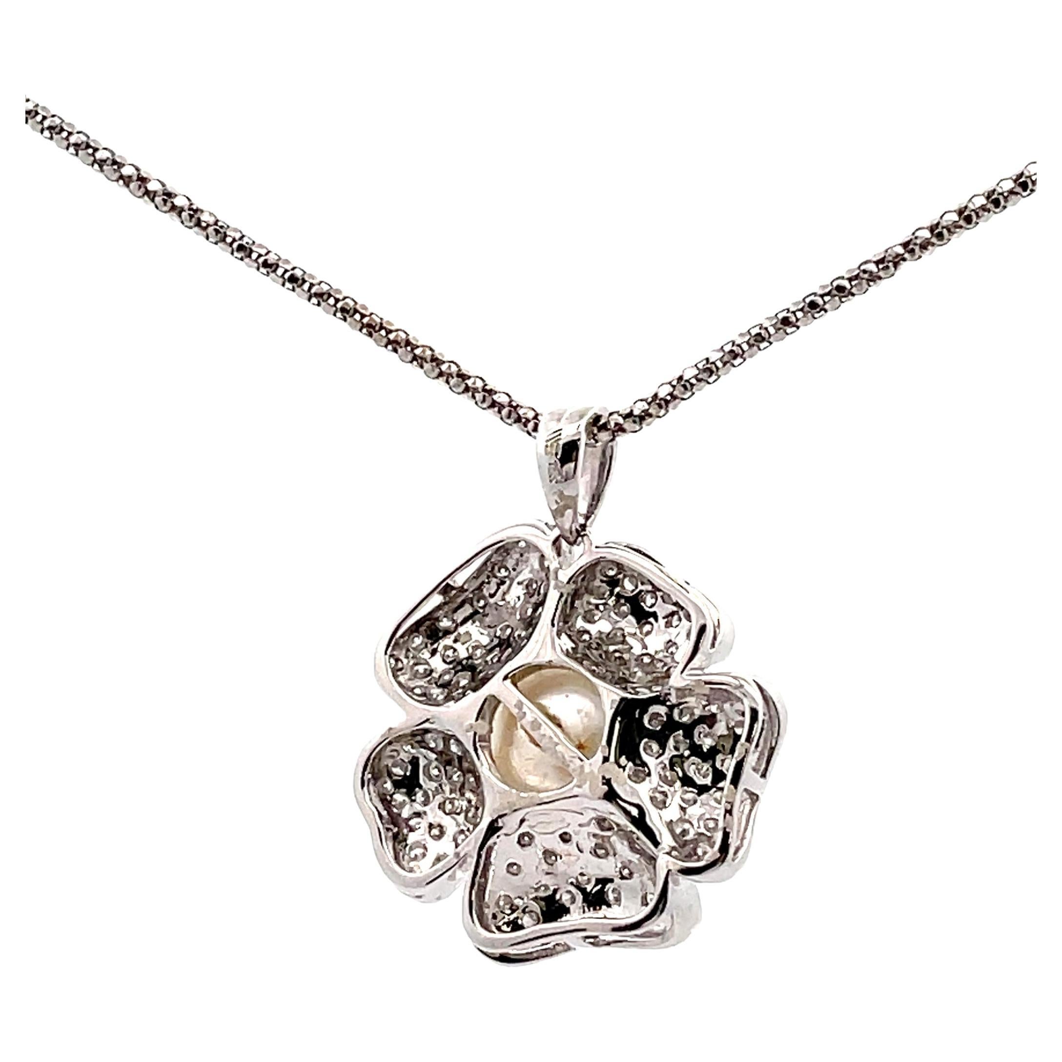 18K white gold flower pendant with 1.25 carats diamonds and one South Sea pearl meausring 14.85mm.
Pendant slides on a 14K white gold chain, 16 inches long.

* Diamonds are H color, SI clarity