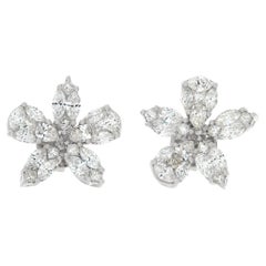 White gold flower shaped illusion set diamond earrings