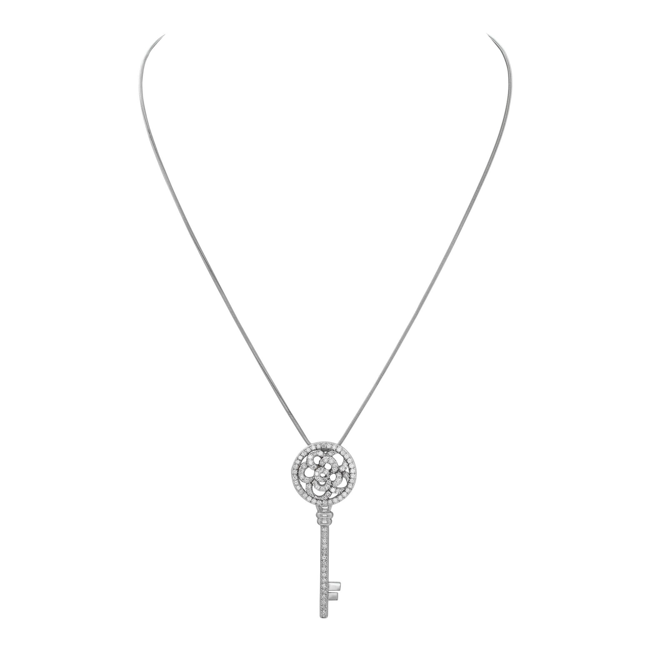 White gold flower-skeleton key pendant w/ pave set diamonds with platinum chain