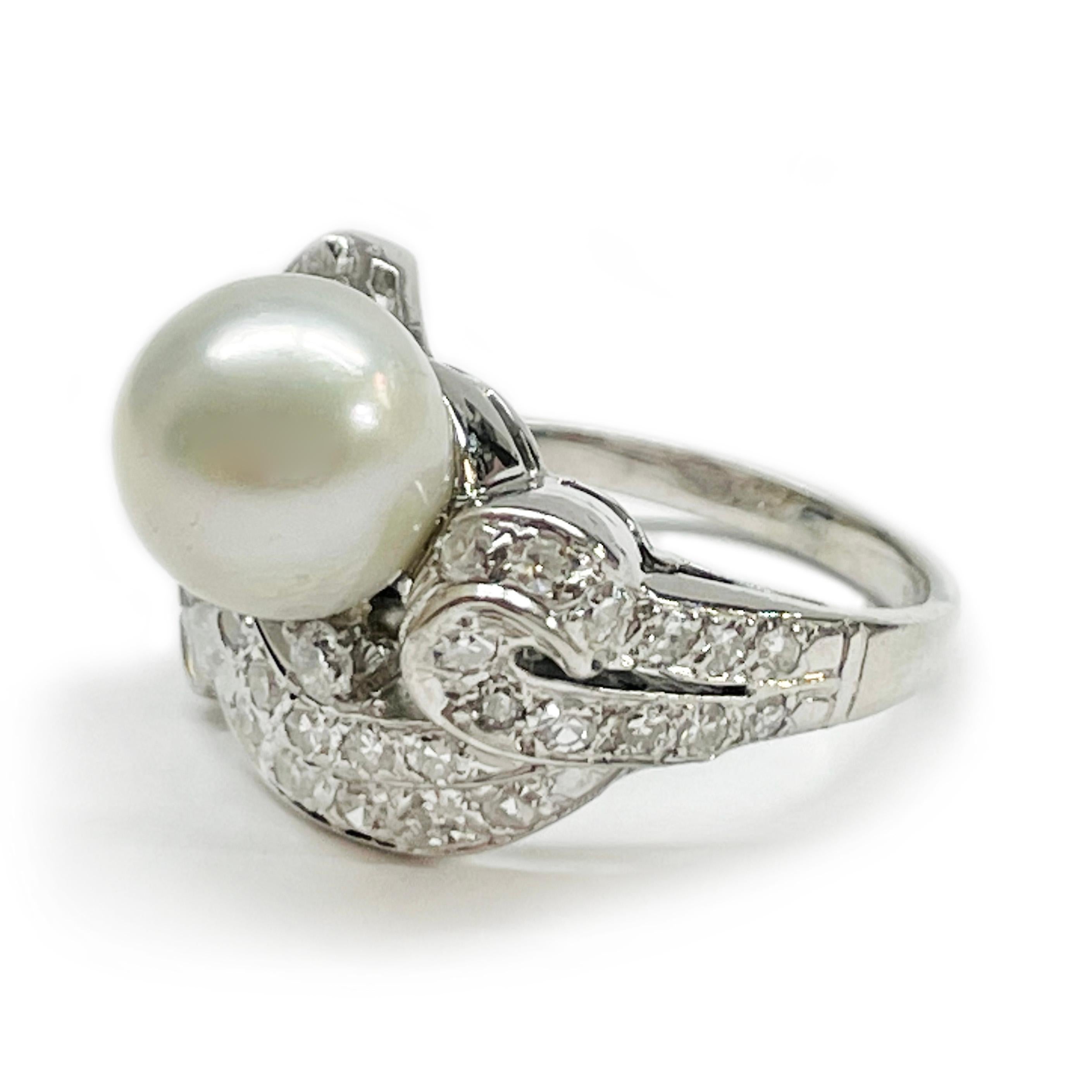 14 Karat White Gold Freshwater Pearl Diamond Ring. The ring features a 9mm center freshwater pearl with baguette and round diamonds. The asymmetrical design consists of milgrain detail and twenty-five round diamonds weighing approximately 0.38twc