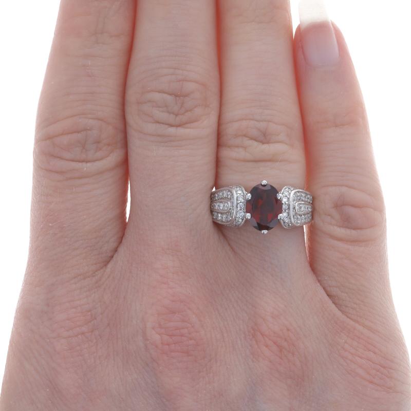 Size: 4 3/4
Sizing Fee: Up 2 sizes for $50

Metal Content: 14k White Gold

Stone Information
Natural Garnet
Carat(s): 2.10ct
Cut: Oval
Color: Red

Natural Diamonds
Carat(s): 1.00ctw
Cut: Round Brilliant
Color: H - I
Clarity: SI1 - SI2

Total Carats: