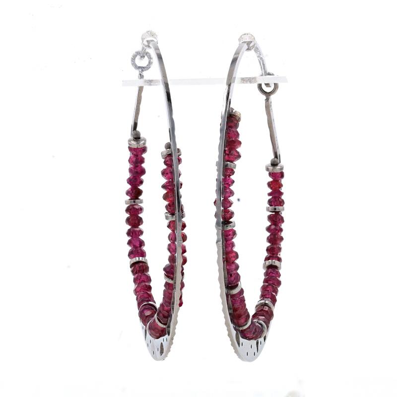 Metal Content: 14k White Gold (with black rhodium finish)

Stone Information
Natural Garnets
Cut: Rondelle
Color: Purplish Red

Style: Hoop
Fastening Type: Slide Closures
Features: Etched & Open Cut Detailing

Measurements
Tall: 1 11/16