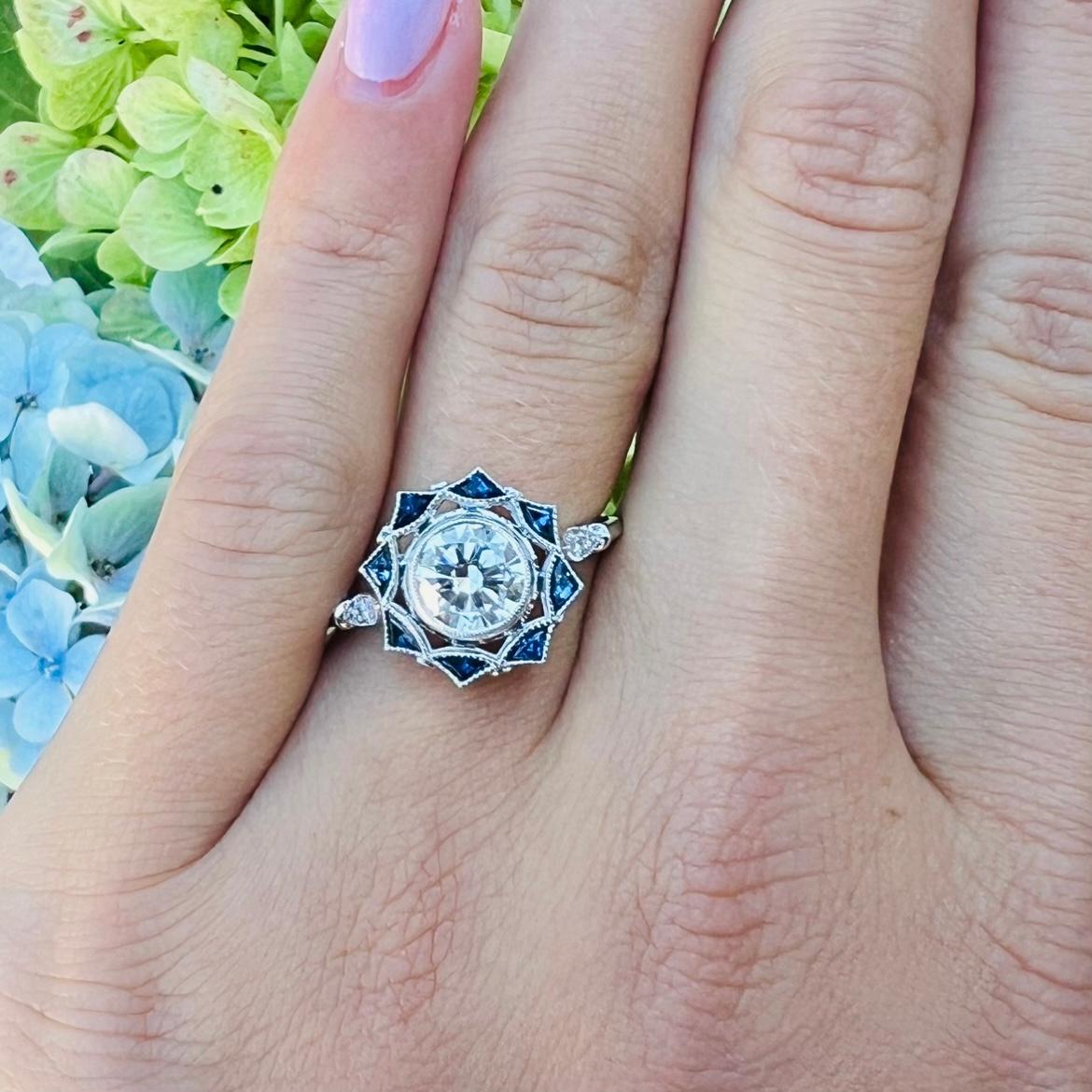 With just the right amount of blue to make it stand out in a crowd, this might be the perfect engagement ring for someone looking for something with a bit of a twist from the norm. With a stunning natural GIA graded diamond weighing .95 carats as