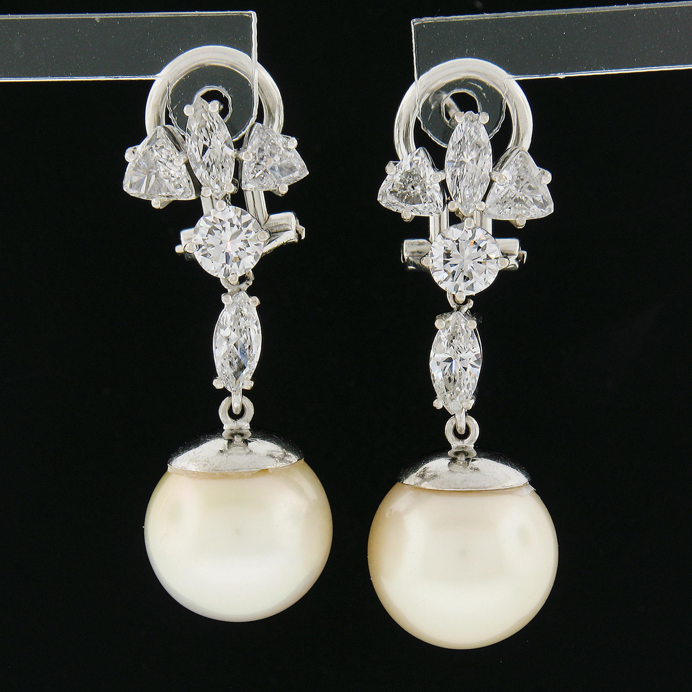 This magnificent pair of dangle drop statement earrings was crafted from solid 14k  white gold. They each feature a very large, GIA certified, saltwater cultured pearl at their dangle, toped by a high fine quality trillion, marquise & round