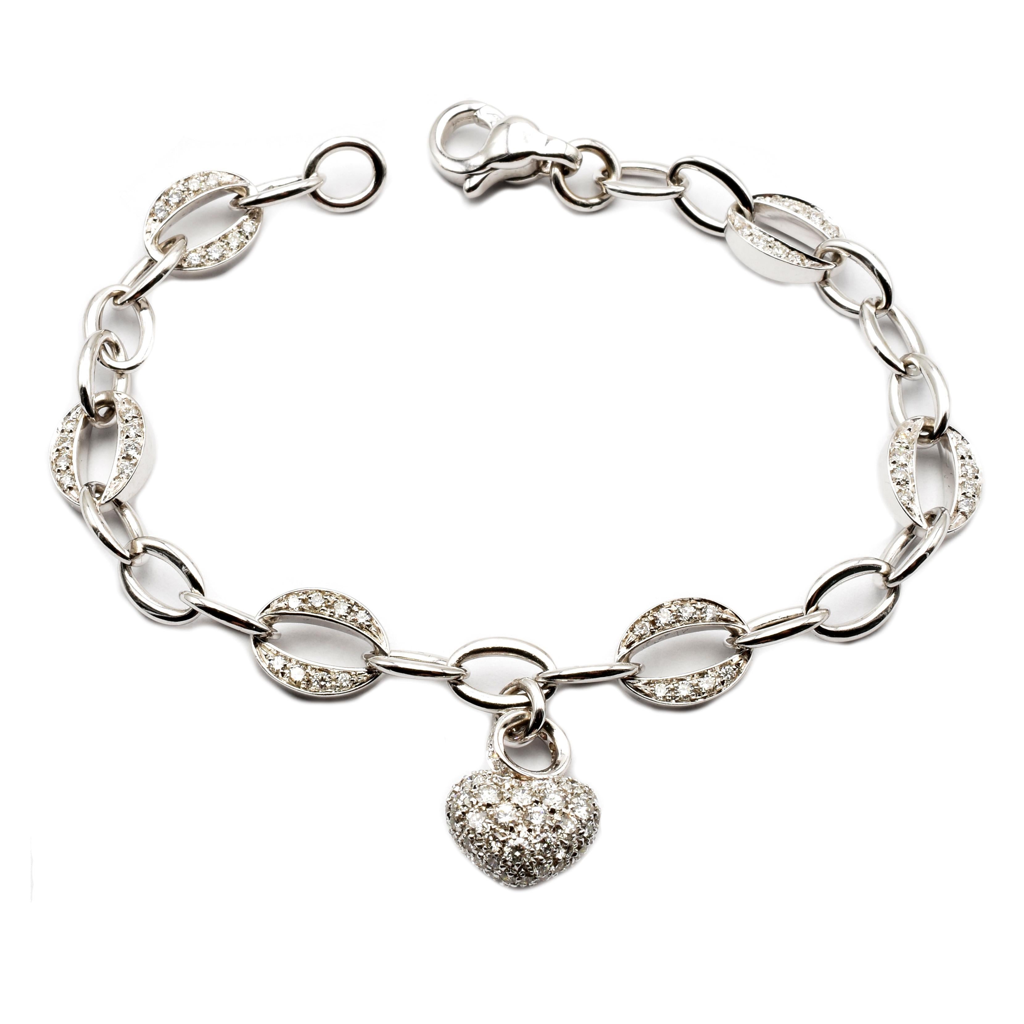 18 Kt White Gold Charm Bracelet with a Hanging Heart Completely set in White Diamonds. 
Handmade in Italy in our Atelier in Valenza (AL).
18Kt Gold g 15.50
White Diamonds (G Color Vs Clarity) ct 2.42
The Heart is fullly set with Diamonds. There is