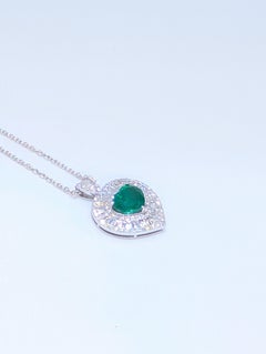White Gold Heart Shape Pendant w/Heart Shape Emerald Surrounded with Diamonds.