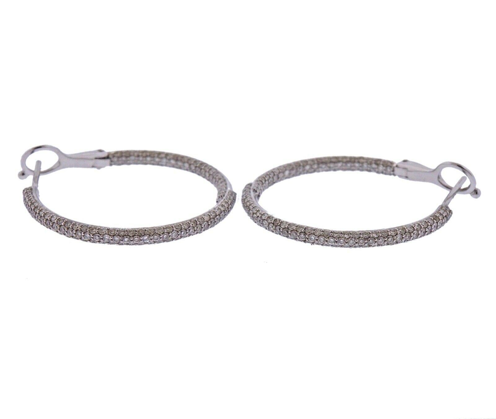 Pair of 14k white gold hoop earrings, with approx. 1.80ctw in H/Si diamonds.  Earrings measure 29mm in diameter, 2mm wide, weight - 6.9 grams. 