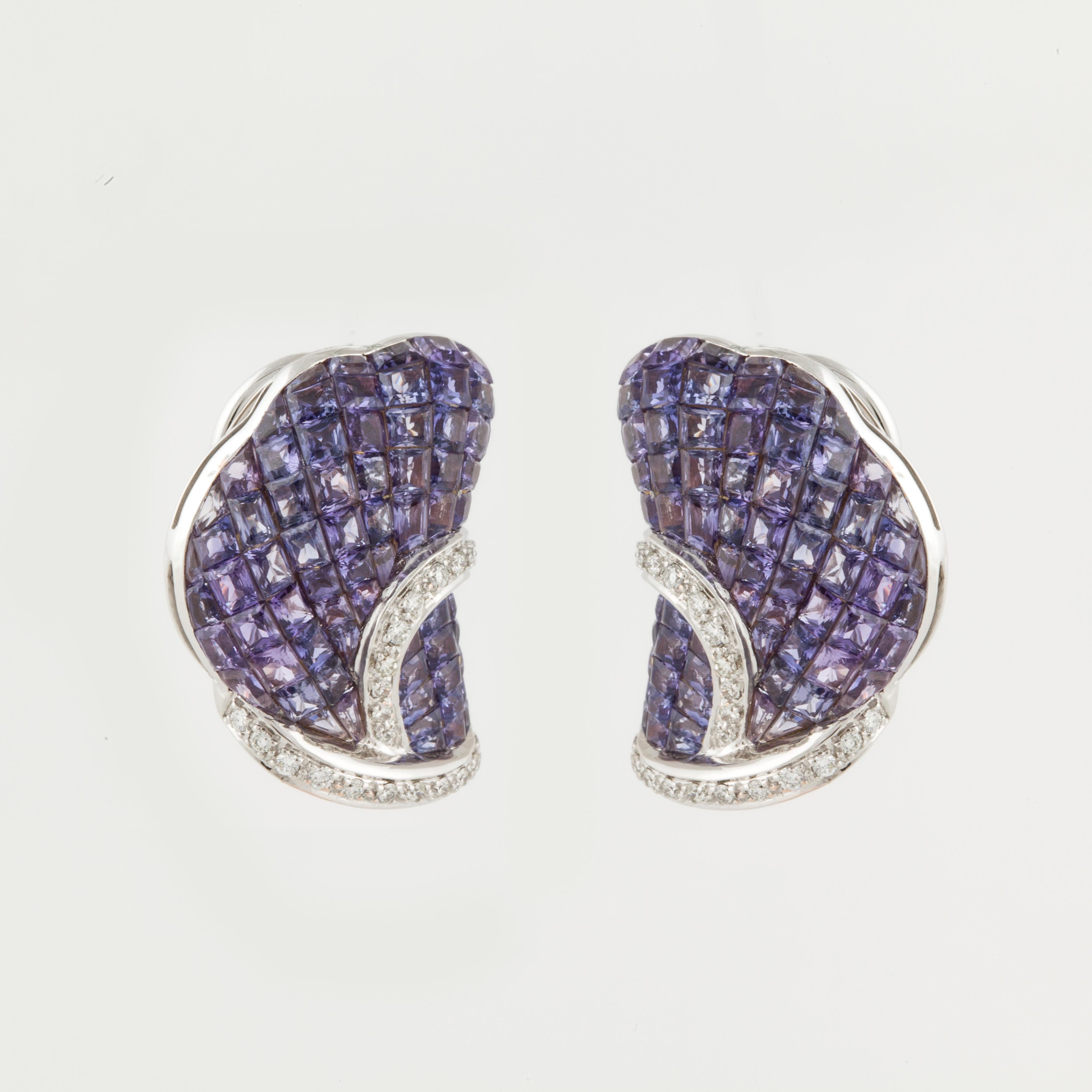 18K white gold earrings with invisible-set purple sapphires and diamonds designed by Nini.    There are 140 princess-cut purple sapphires that total 18.50 carats.  In addition, there are 44 round diamonds totaling 0.65 carats; H-I color and VS2