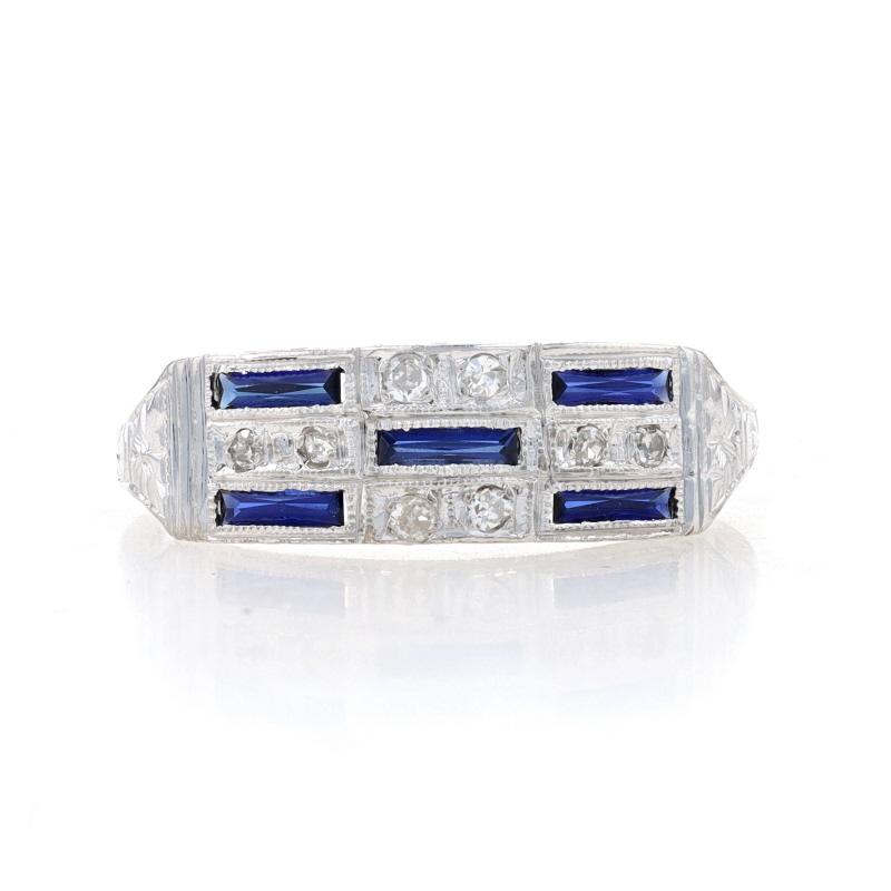 Size: 6 3/4

Era: Art Deco
Date: 1920s - 1930s

Metal Content: 18k White Gold

Stone Information
Synthetic Sapphires
Cut: French Cut Baguette
Color: Blue

Natural Diamonds
Carat(s): .06ctw
Cut: Single
Color: H - I
Clarity: SI1 - SI2

Style: