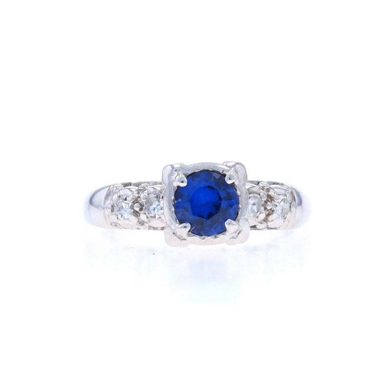 Size: 4 3/4
Sizing Fee: Up 3 sizes for $35 or Down 1 size for $35

Era: Vintage

Metal Content: 14k White Gold

Stone Information

Synthetic Spinel
Carat(s): .38ct
Cut: Round
Color: Blue

Natural Diamonds
Carat(s): .10ctw
Cut: Single
Color: