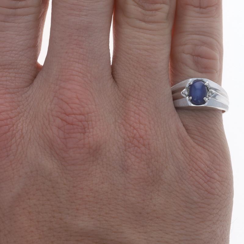 Size: 8
Sizing Fee: Up 2 sizes for $35

Metal Content: 10k White Gold

Stone Information
Synthetic Star Sapphire
Carat(s): 1.60ct
Cut: Oval Cabochon
Color: Blue

Natural Diamonds
Carat(s): .03ctw
Cut: Single
Color: H - I
Clarity: SI2 - I1

Total