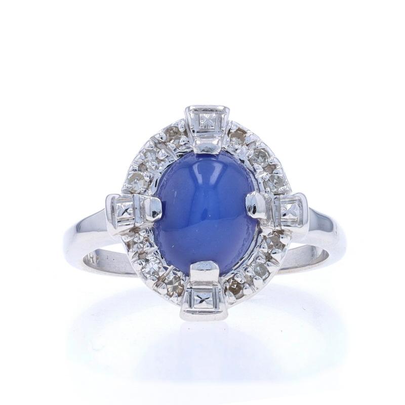 Size: 6 3/4
Sizing Fee: Up 2 sizes for $35 or Down 1 1/2 sizes for $35

Era: Vintage

Metal Content: 14k White Gold

Stone Information

Synthetic Star Sapphire
Carat(s): 1.70ct
Cut: Oval Cabochon
Color: Blue

Natural Diamonds
Carat(s): .12ctw
Cut: