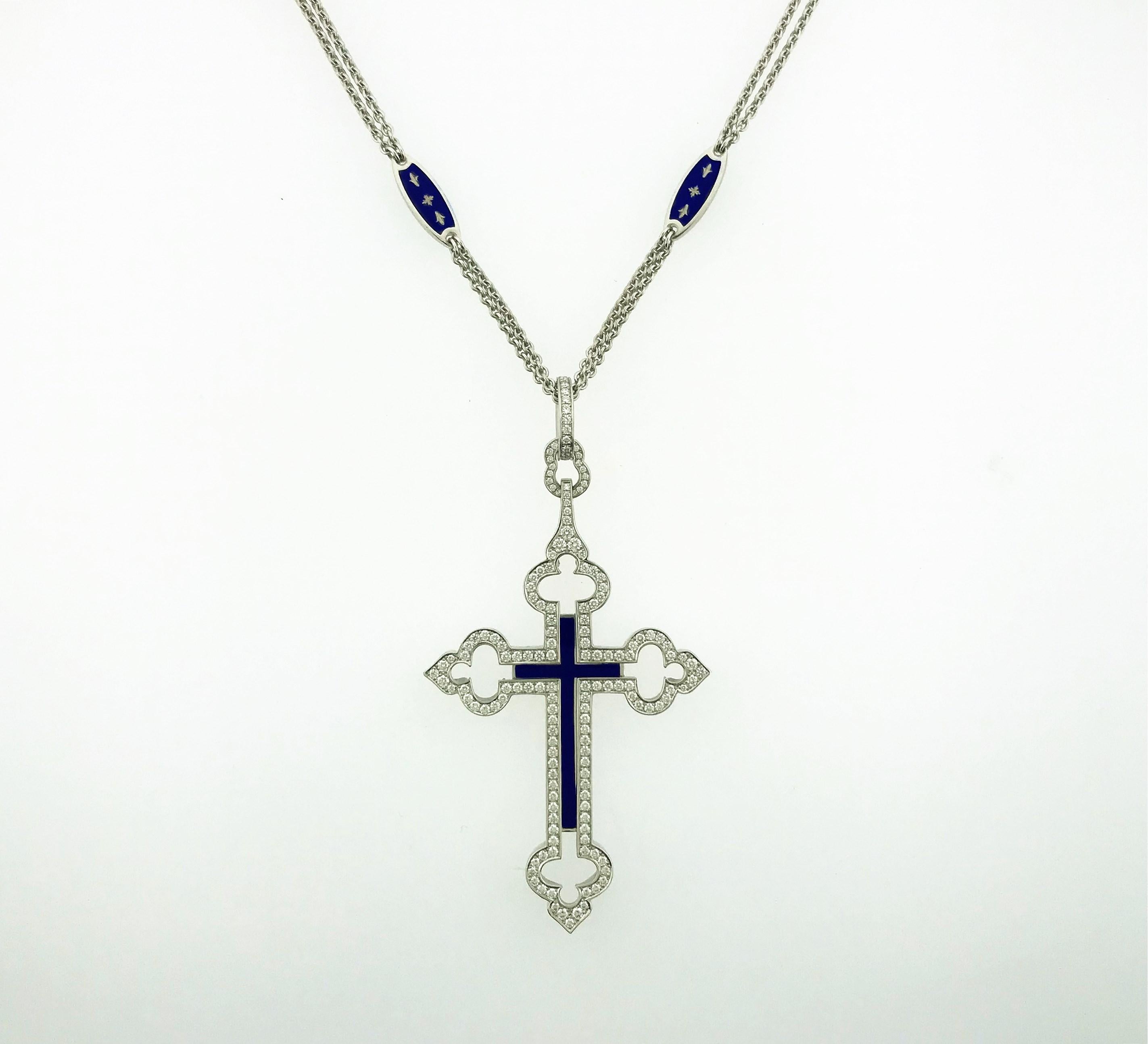 18K white gold, cobalt-blue enameled and diamond limited-edition Fabergé cross pendant with a diamond bale. The pendant centers a blue-enameled cross flanked by a single row of bead-set round brilliant cut diamonds extending to four decorative