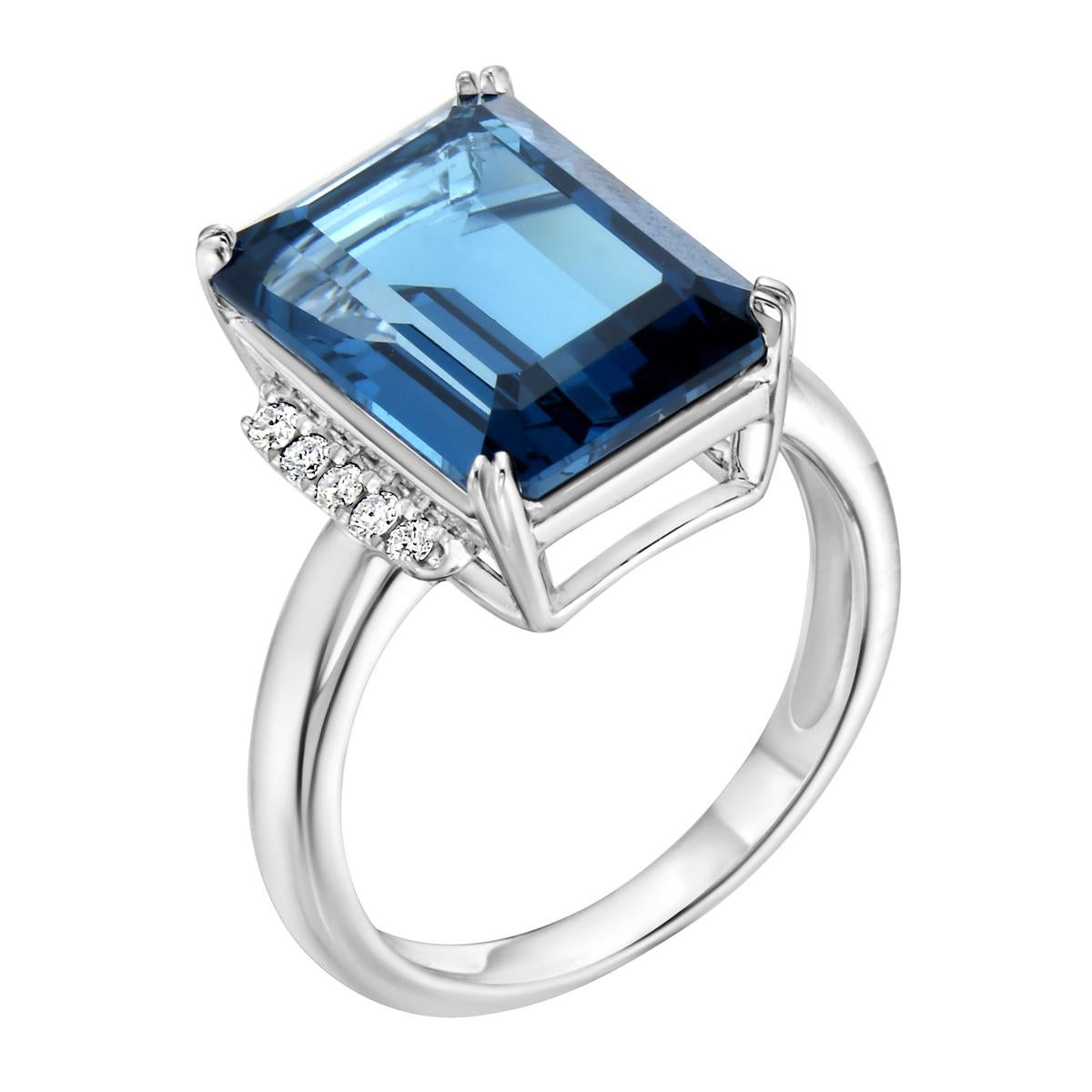 With this exquisite semi-precious white gold London blue topaz emerald cut diamond ring, style and glamour are in the spotlight. This 14-karat ring is made from 3.8 grams of gold and 1 London blue topaz totaling 8.94 karats. This ring is also