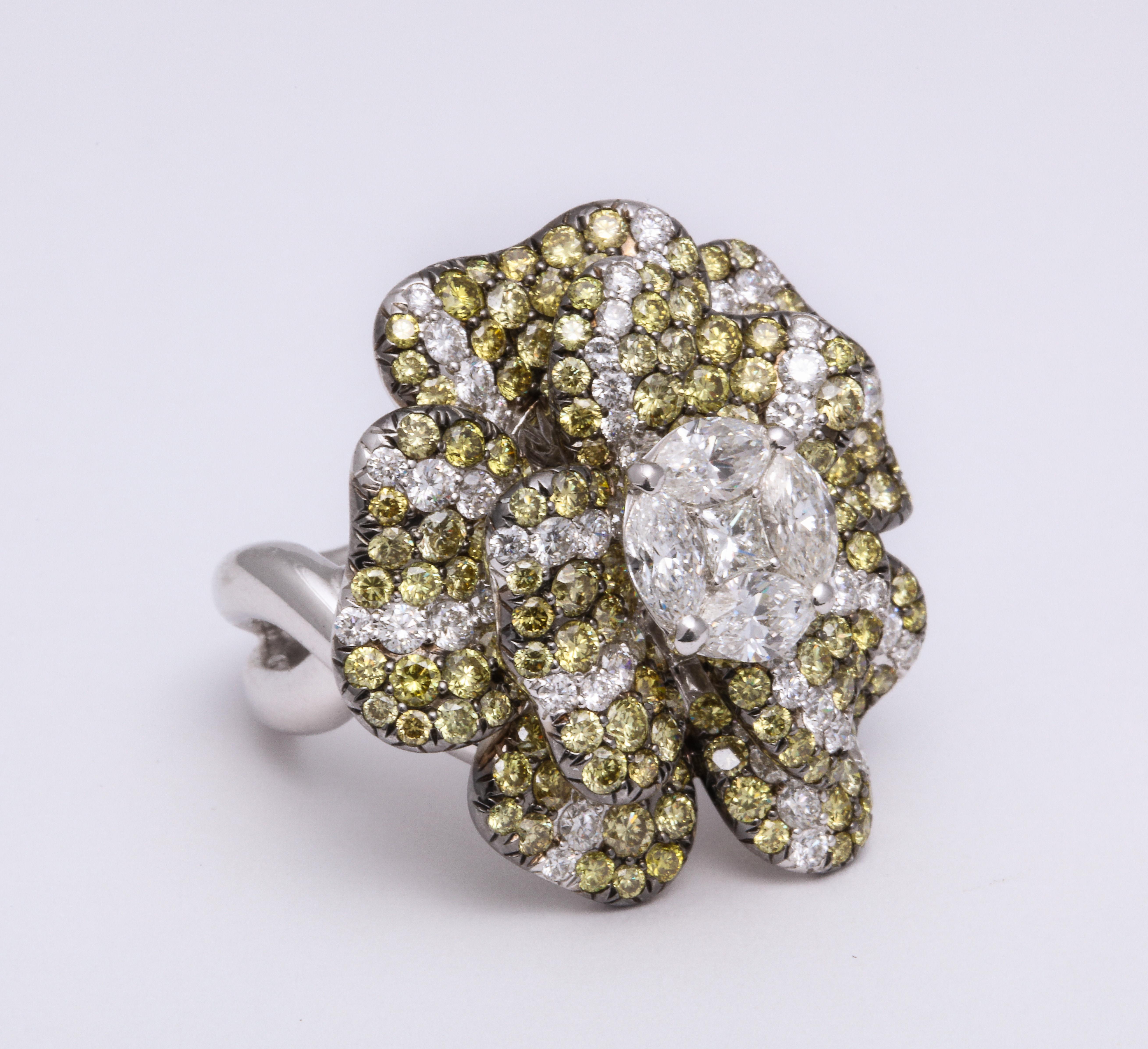 Bright and happy 18 Karat white gold flower blossom ring composed of individual petals adding and animated breath to the complete floral.  Completely pave'-set with natural color round brilliant-cut greenish yellow diamonds and wisps of colorless