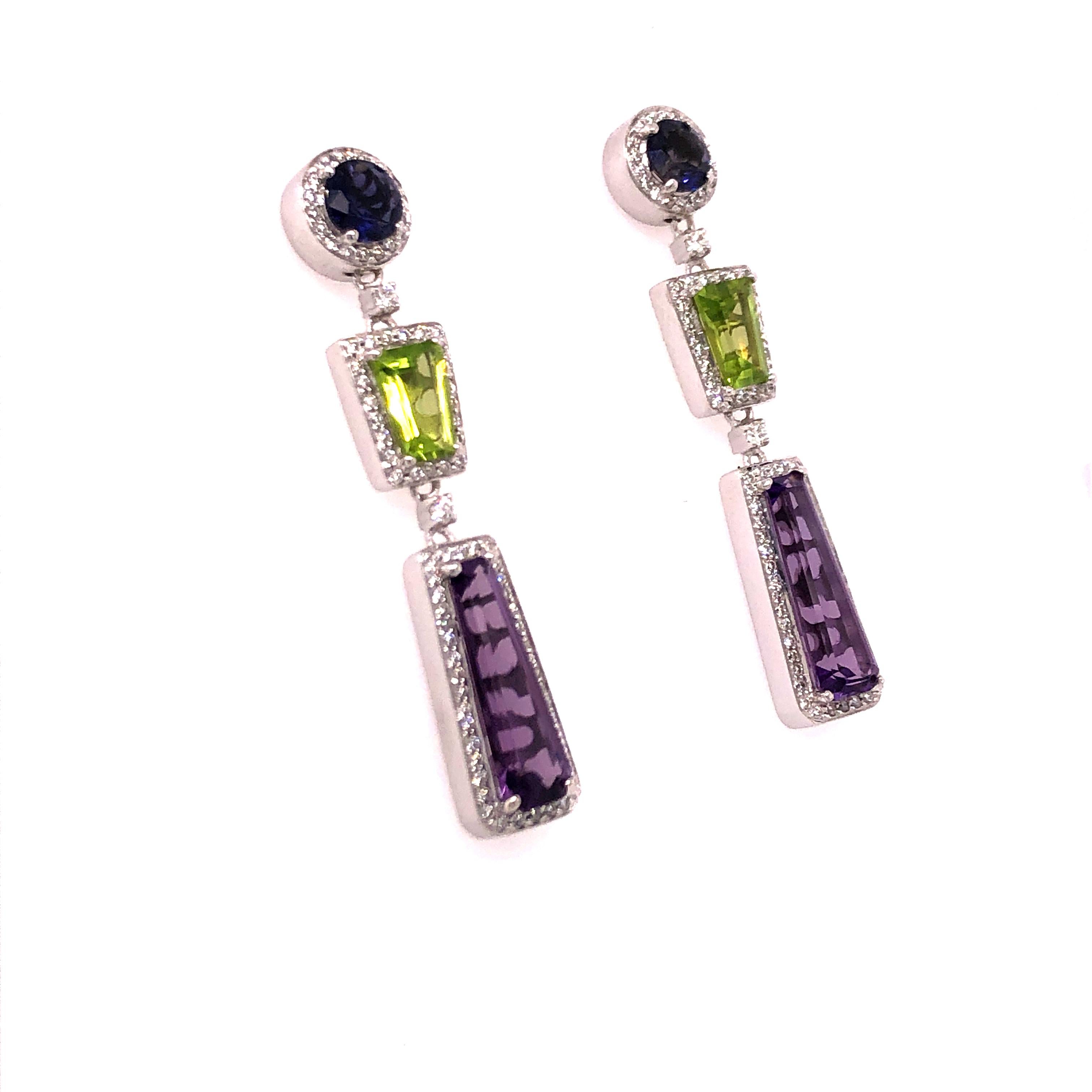 These 14K white gold multi colored stone earrings bring a splash of color to your style. Each of the three geometric shaped stones are surrounded by a halo of diamonds. Where it with the matching necklace (sold separately)! 

