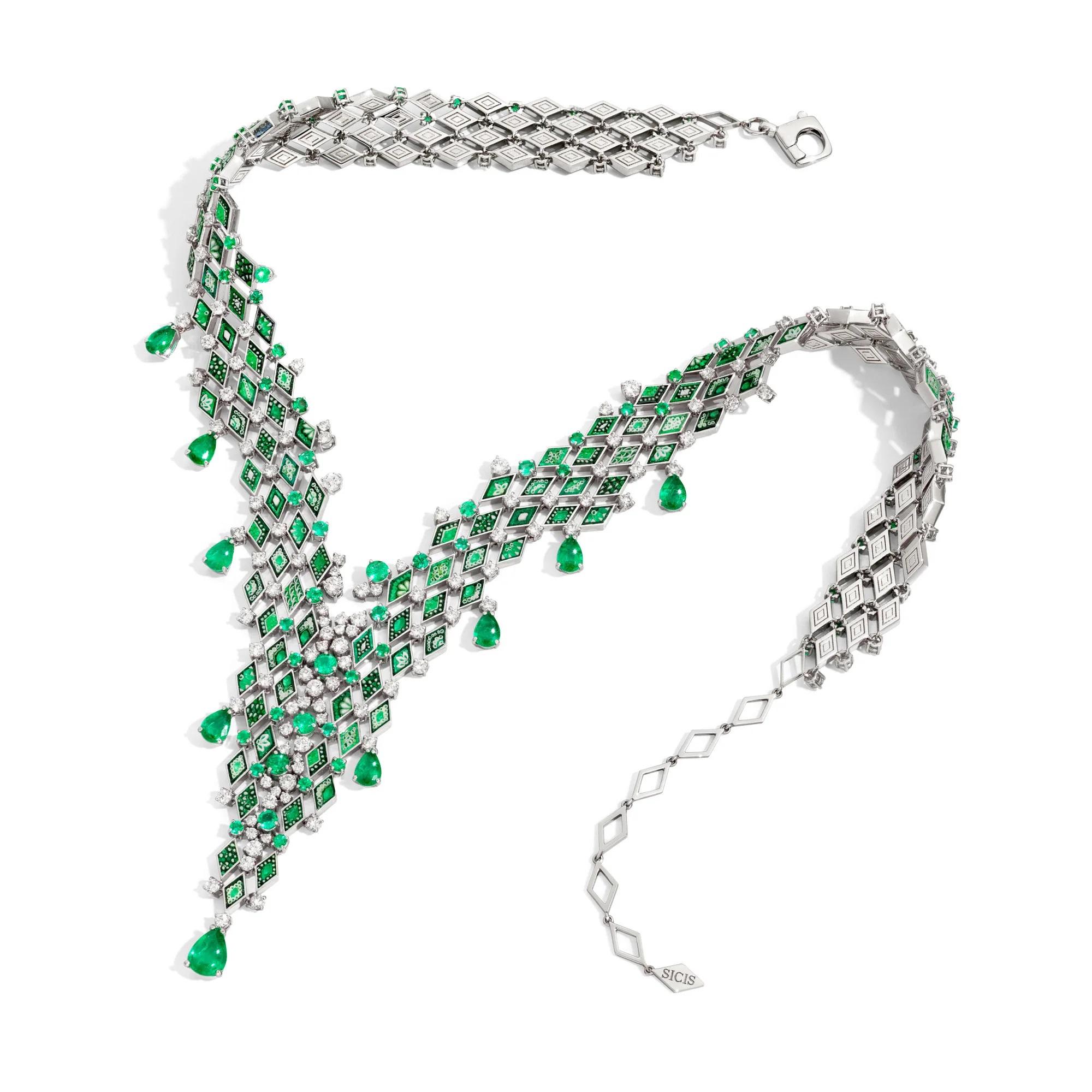 A stunning sinuous shape in white gold, enriched by emeralds and diamonds of the micromosaic tesserae and precious stones.

