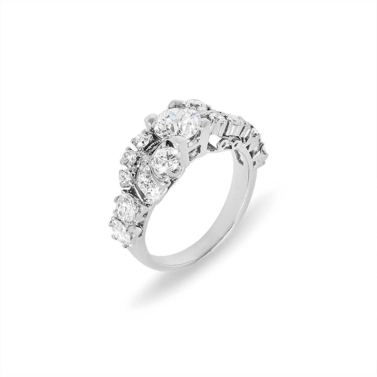 A unique 14k white gold diamond engagement ring. The ring is set to the centre with an Old European cut diamond weighing approximately 0.86ct, H colour and VS clarity. Further complementing the centre diamond are 6 round brilliant cut diamonds and
